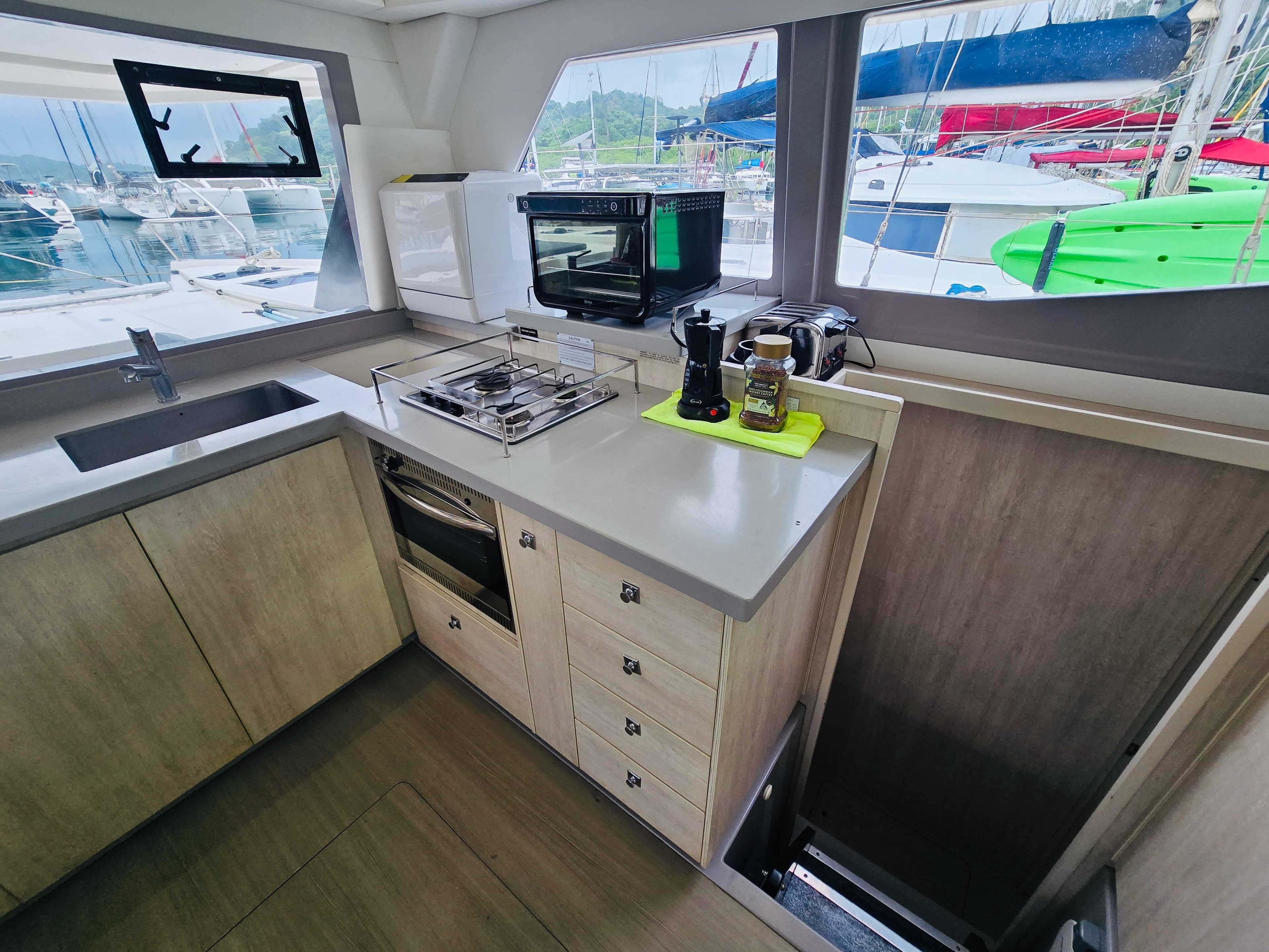 Modern kitchen interior of 2018 Leopard 45 yacht with appliances and marina view.