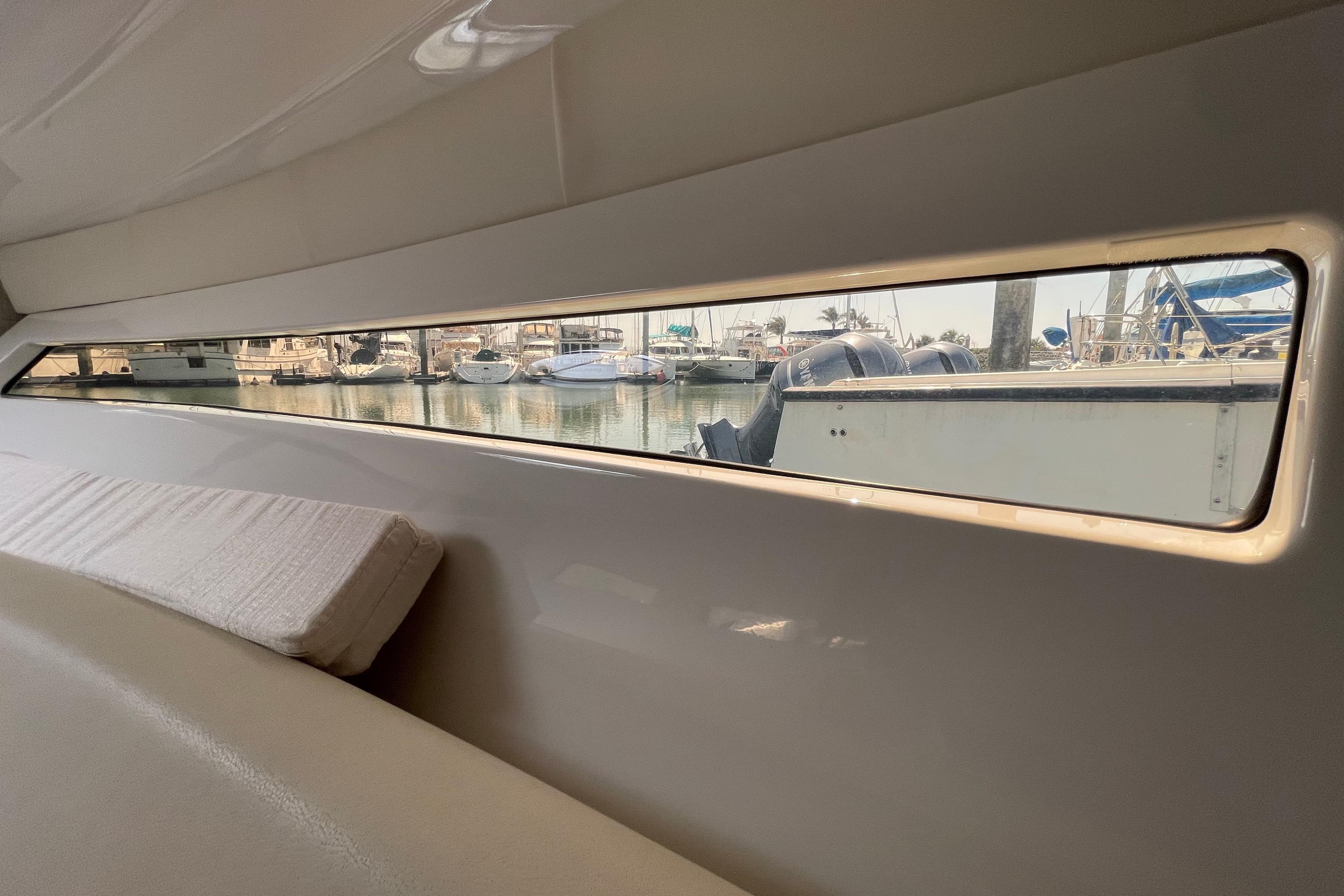 Interior view of 2019 Monterey 295 Sport Yacht with marina through window.