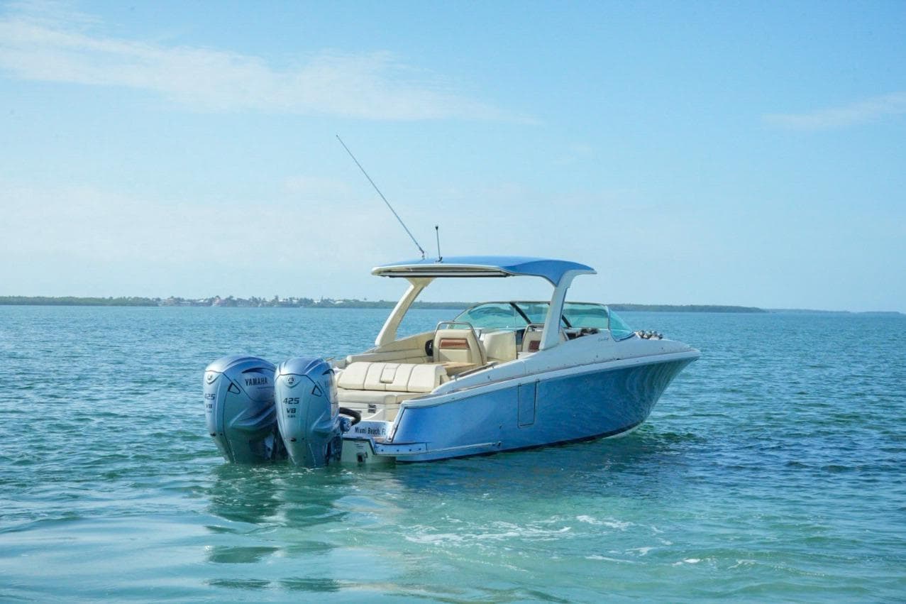 2019 Chris-Craft Launch 35 GT OB boat on calm blue water.
