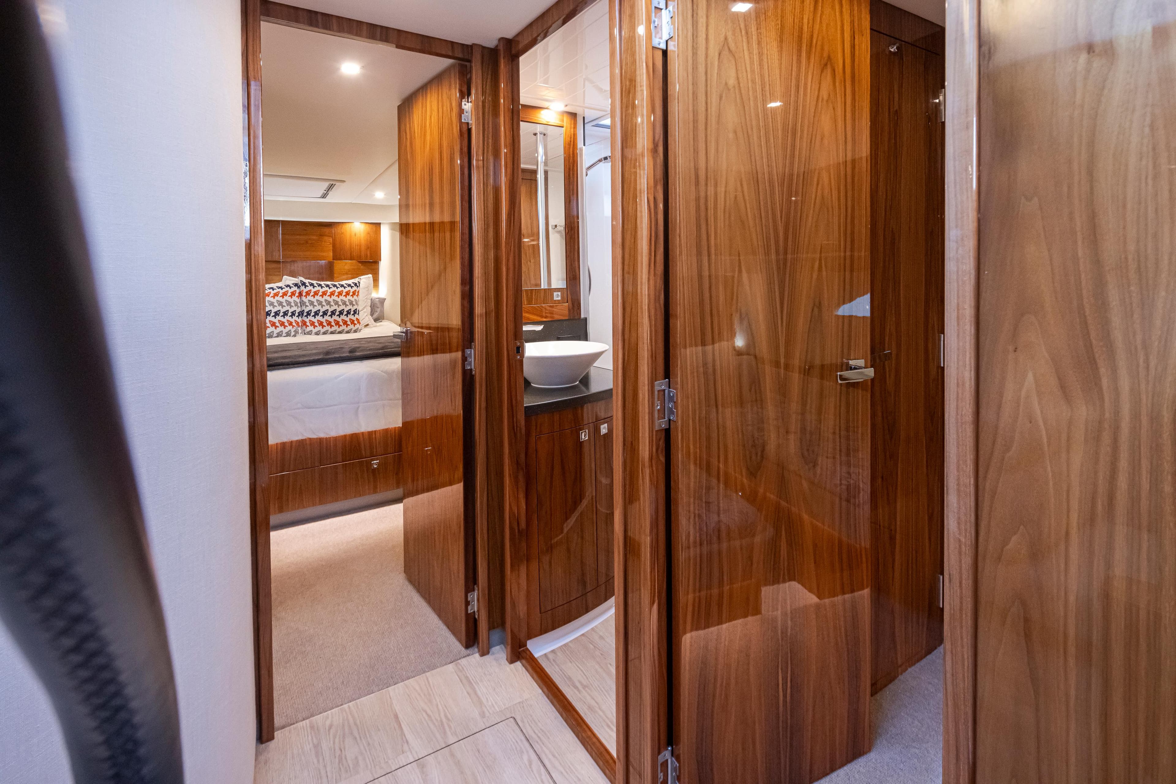 2017 Riviera Sport Cruiser interior with wood finish, showing bedroom and bathroom areas.