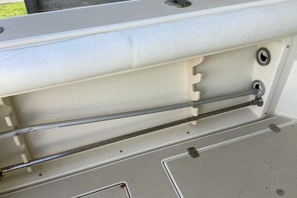 1995 Albin 28 Tournament boat interior detail with rod holders and storage compartment.
