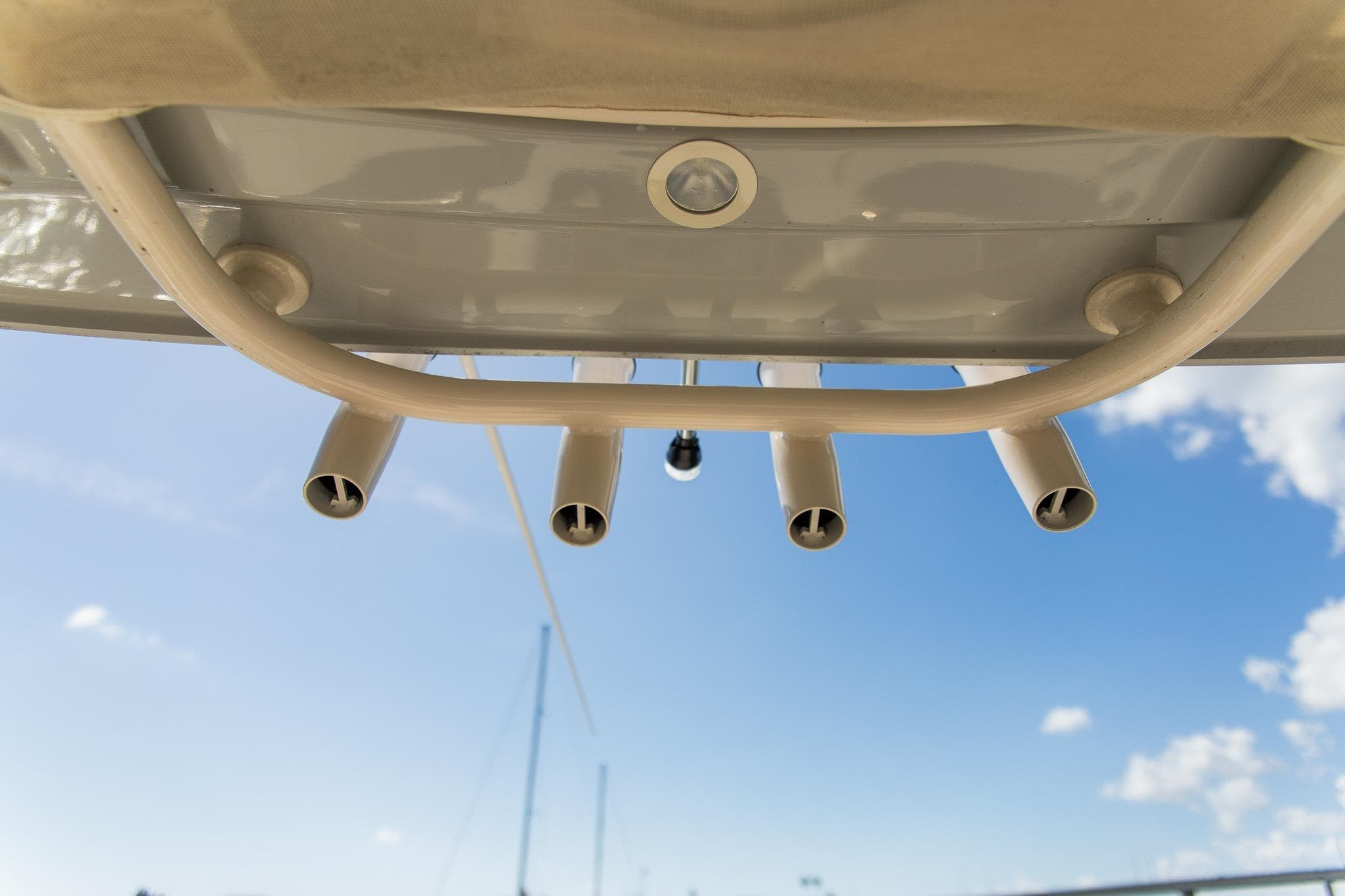 2024 Grady-White 231 Coastal Explorer boat rod holders against blue sky.