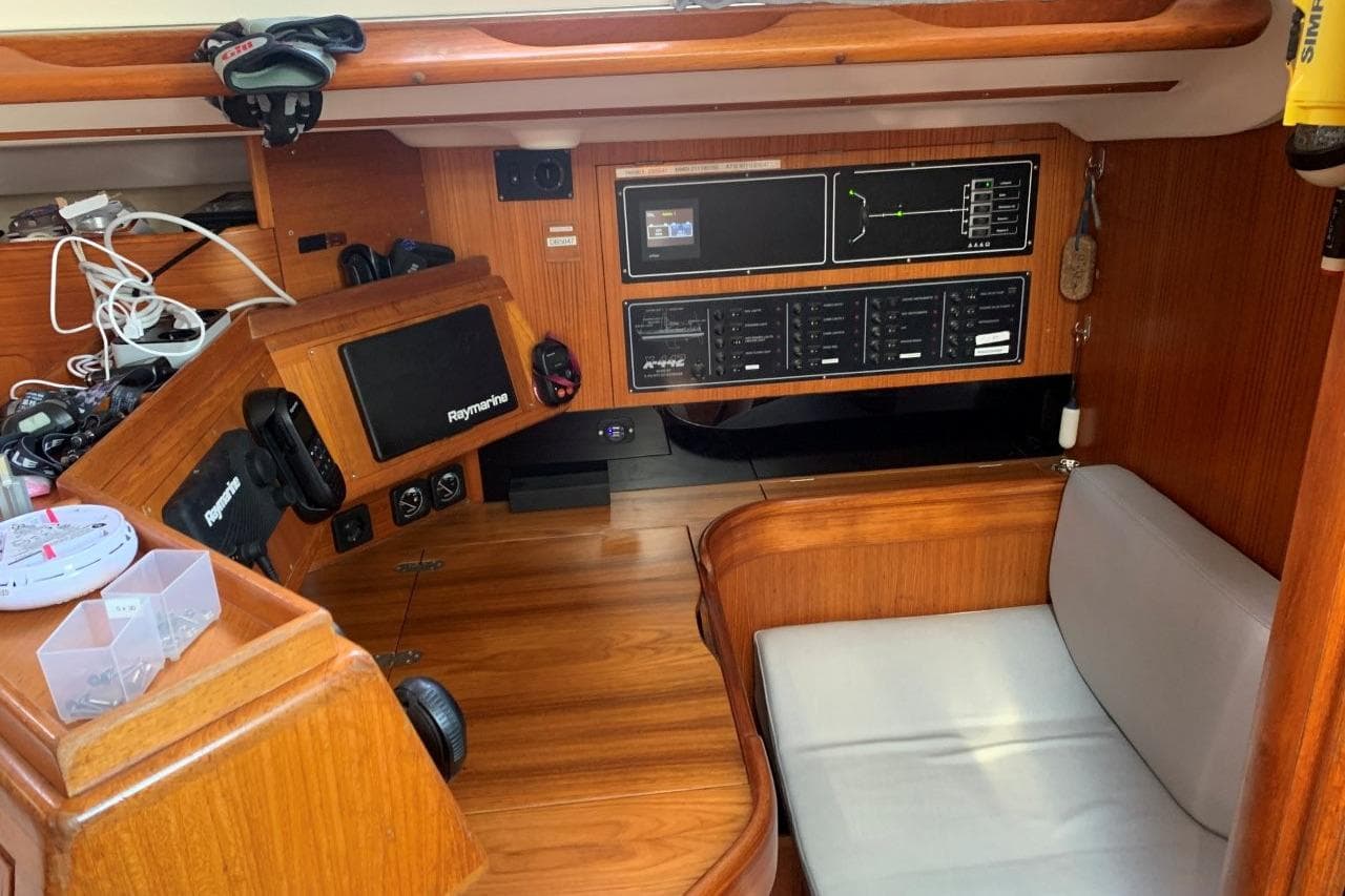 Interior of 1994 X-Yachts X-442 sailboat with navigation equipment and wooden finish.