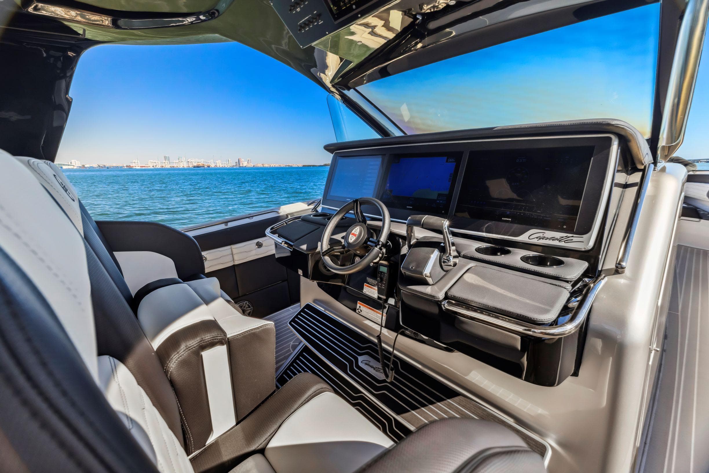Interior of 2022 Cigarette 42 Auroris boat with modern dashboard and steering wheel.