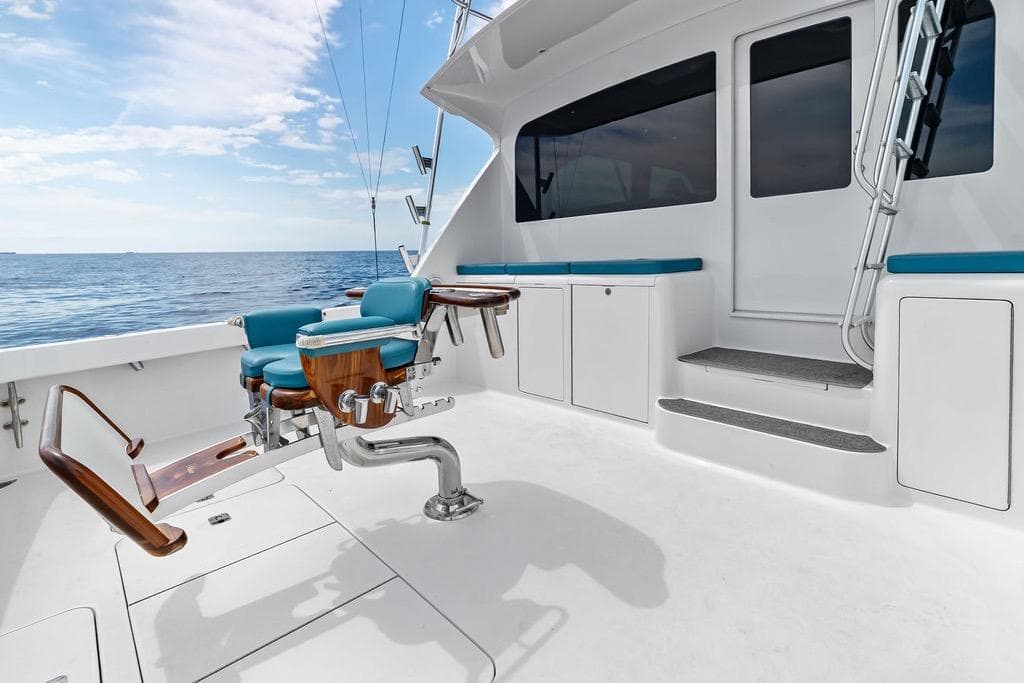 2005 Viking 61 Convertible yacht deck with fishing chair, ocean view, and blue sky.