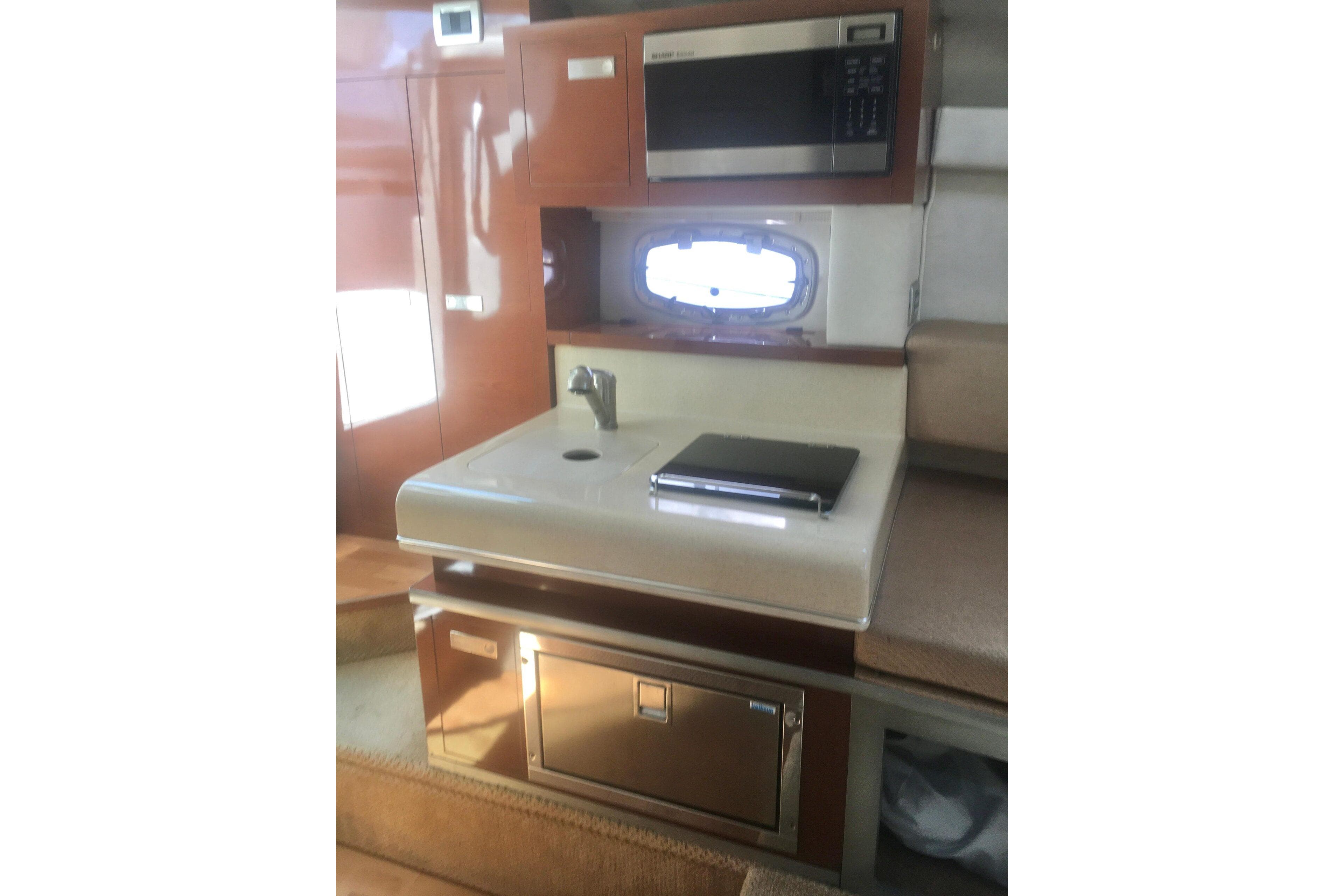 Interior of 2010 Sea Ray 260 Sundancer with kitchenette and microwave.