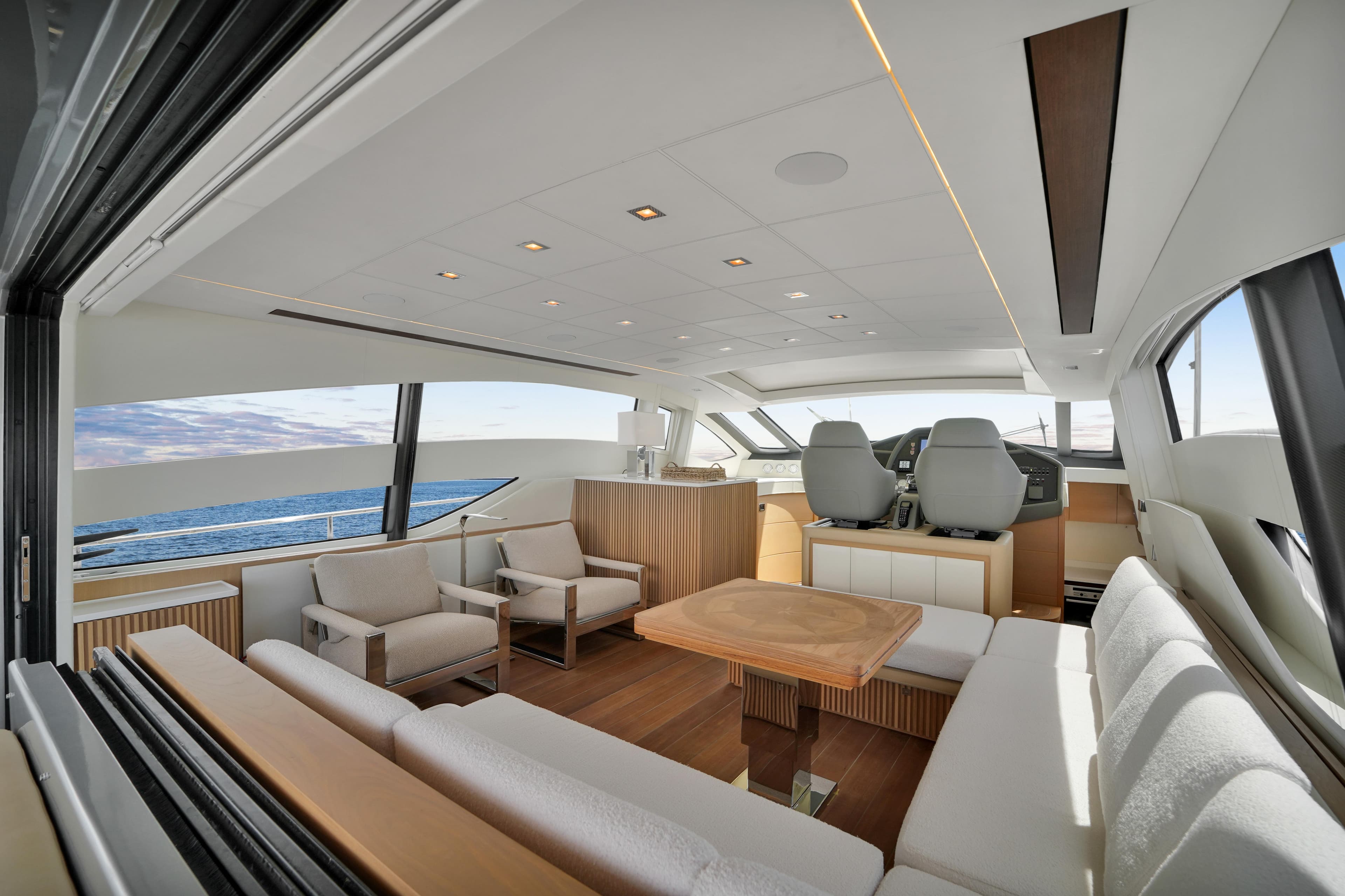 Luxurious interior of a 2009 Pershing 72 yacht with modern seating and ocean view.