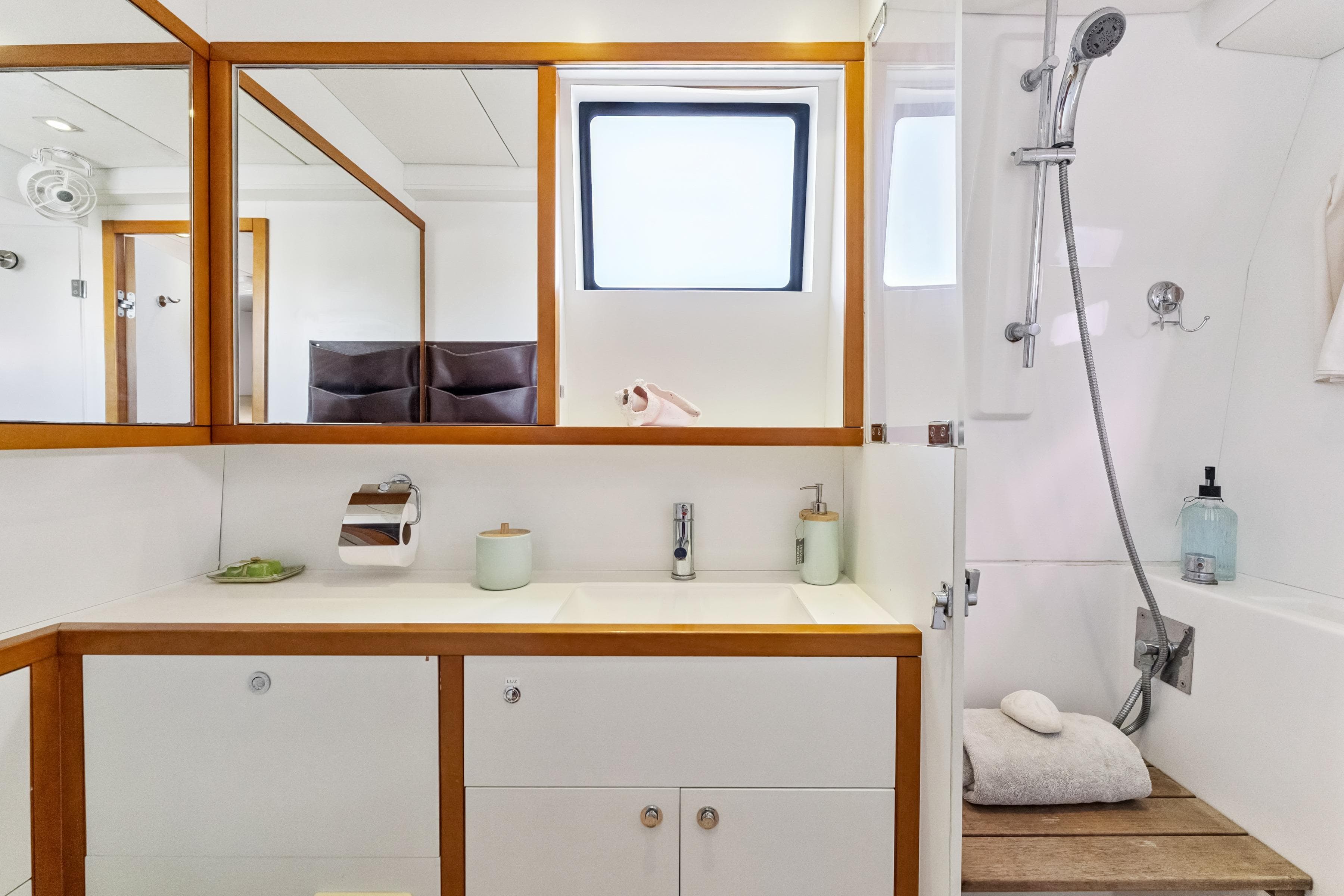Luxurious bathroom in 2012 Lagoon 560 yacht with modern fixtures and wooden accents.