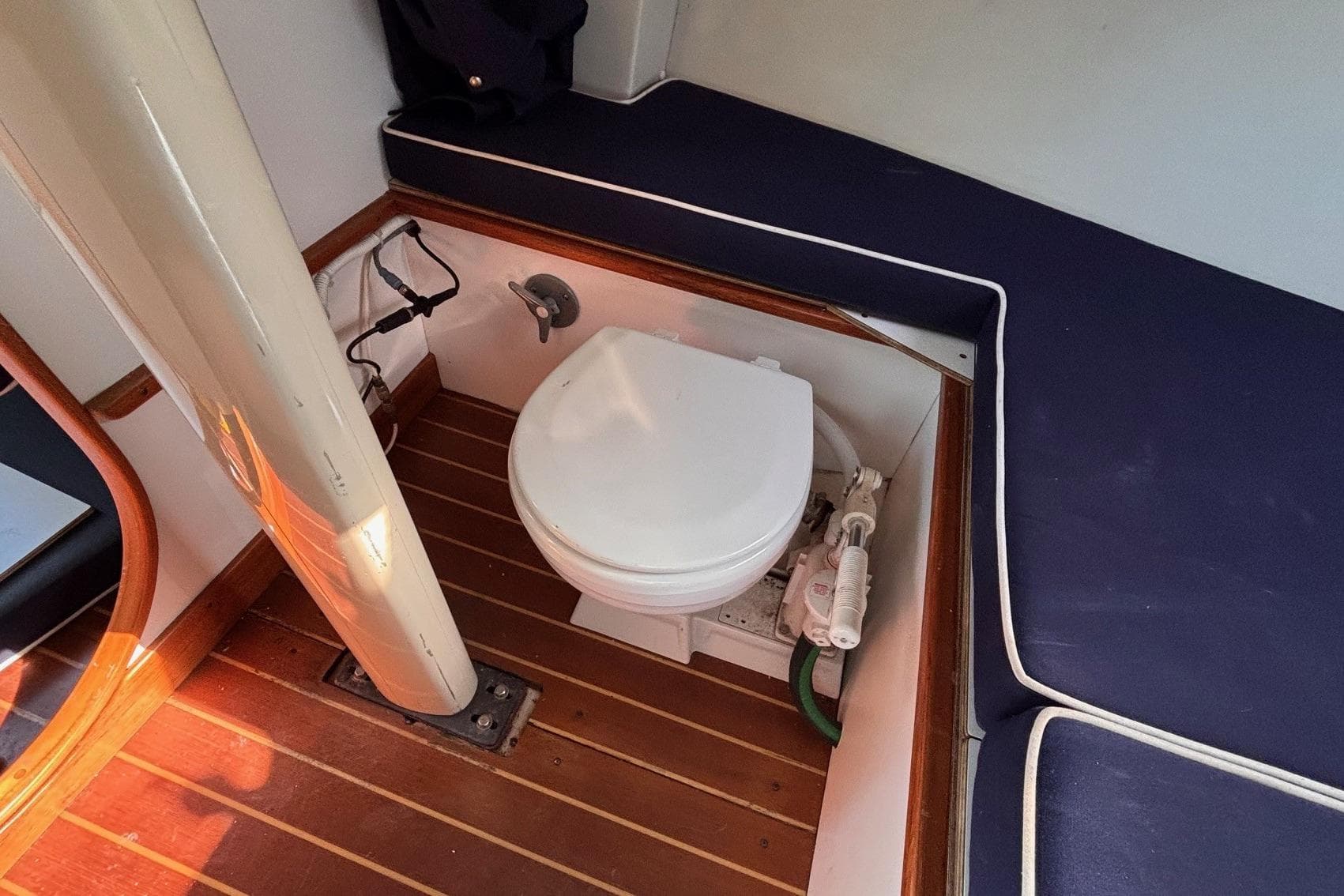 Alerion Express 28 (2016) boat interior with toilet and wooden flooring.