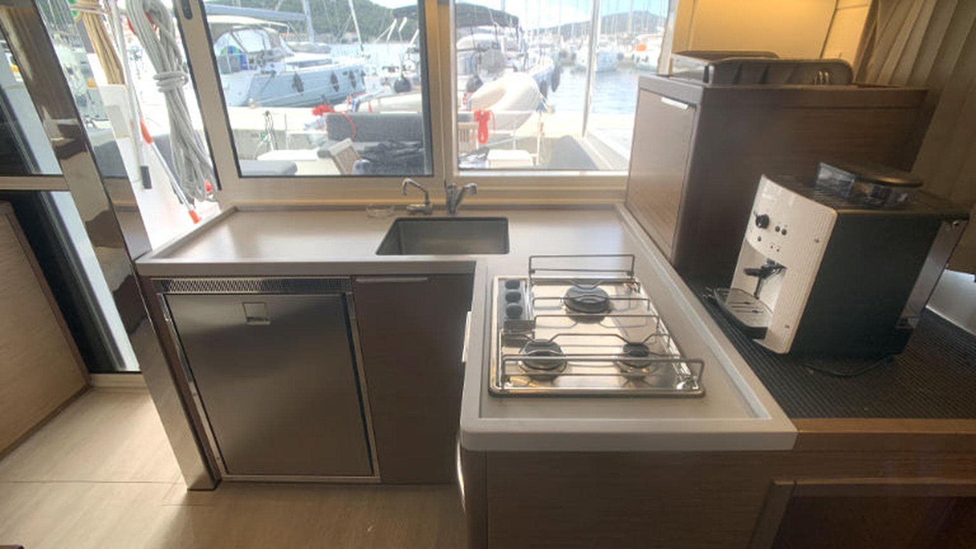 Modern kitchen in 2019 Lagoon 40 catamaran with stove, sink, and coffee maker.