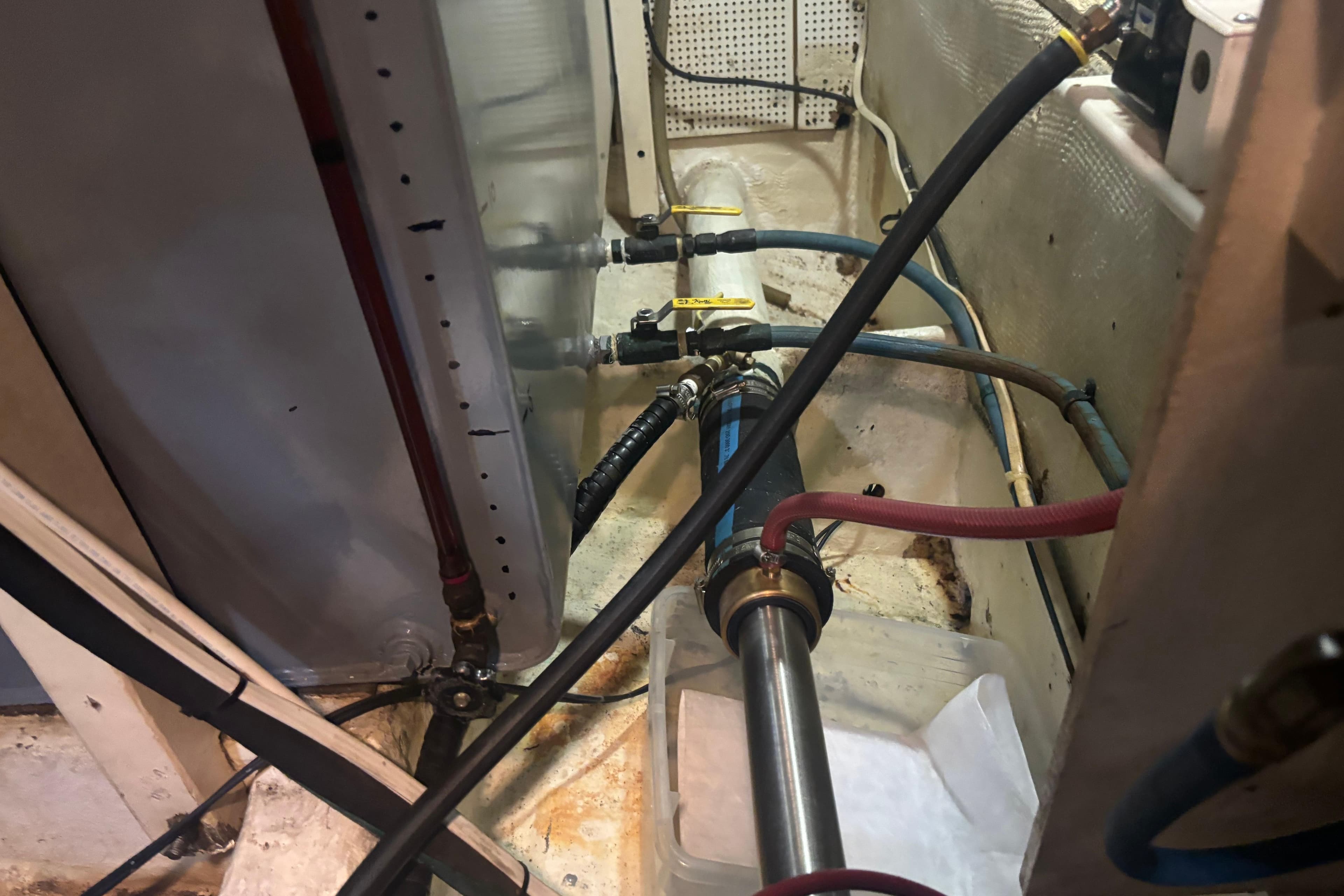 Engine room of 1989 Grand Banks 46 Classic with visible pipes and valves.