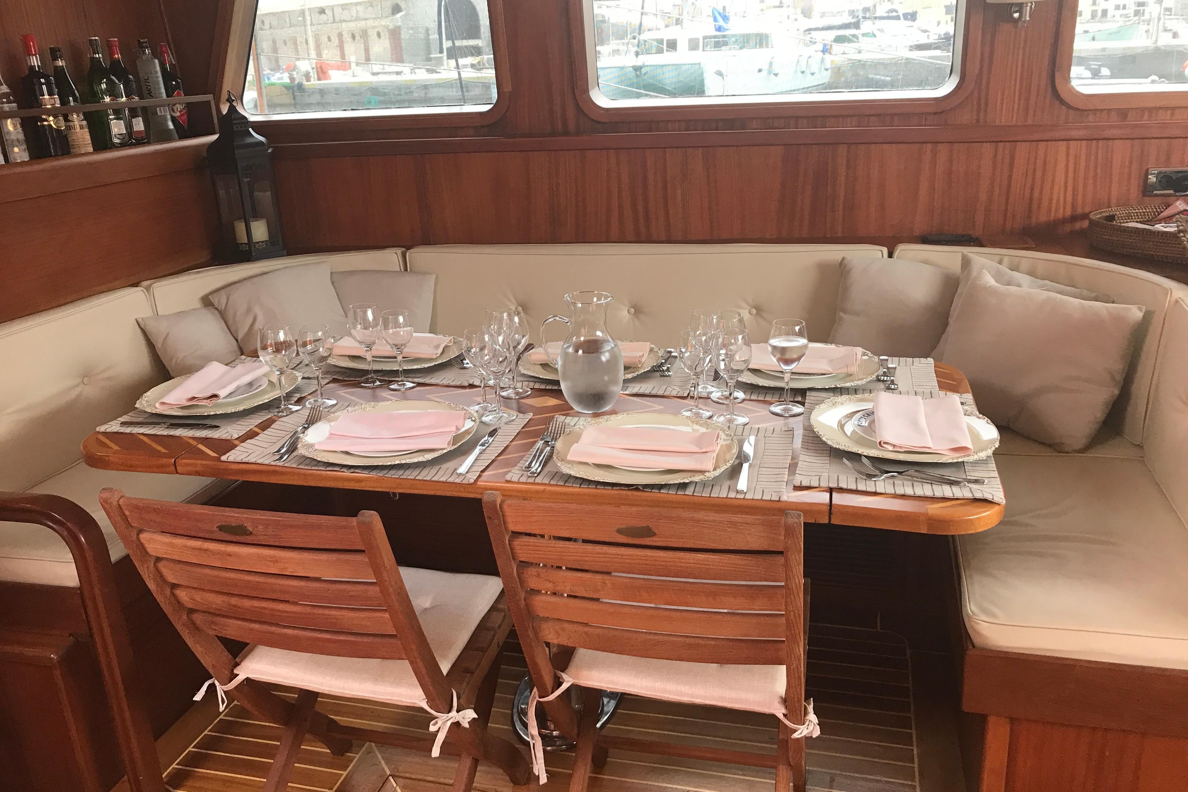 Luxurious dining area on 2007 Neta Marine Neta 27 mt yacht, elegantly set table.