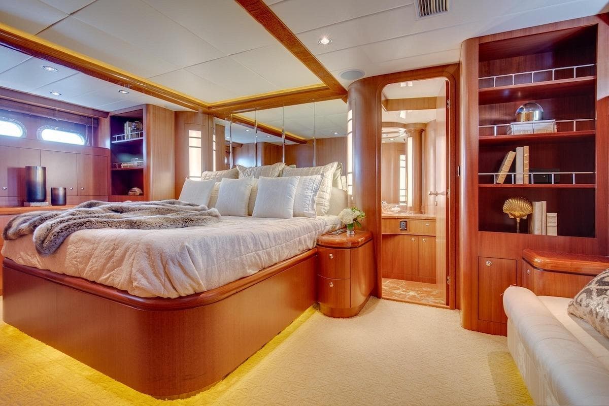 Luxurious bedroom interior of 2008 Horizon 82 Cockpit Motoryacht with elegant wood finishes.