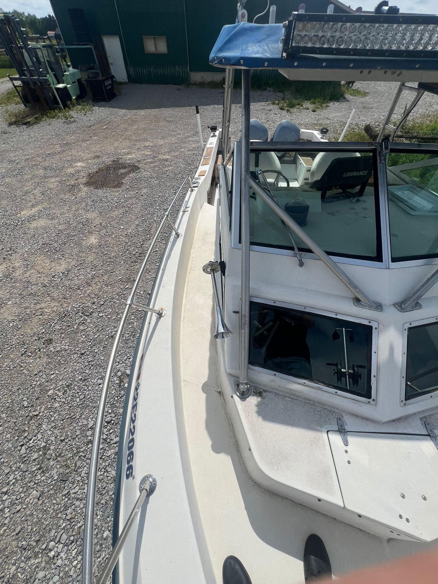 1988 Grady-White Offshore 240 boat on gravel, featuring windshield and railing.