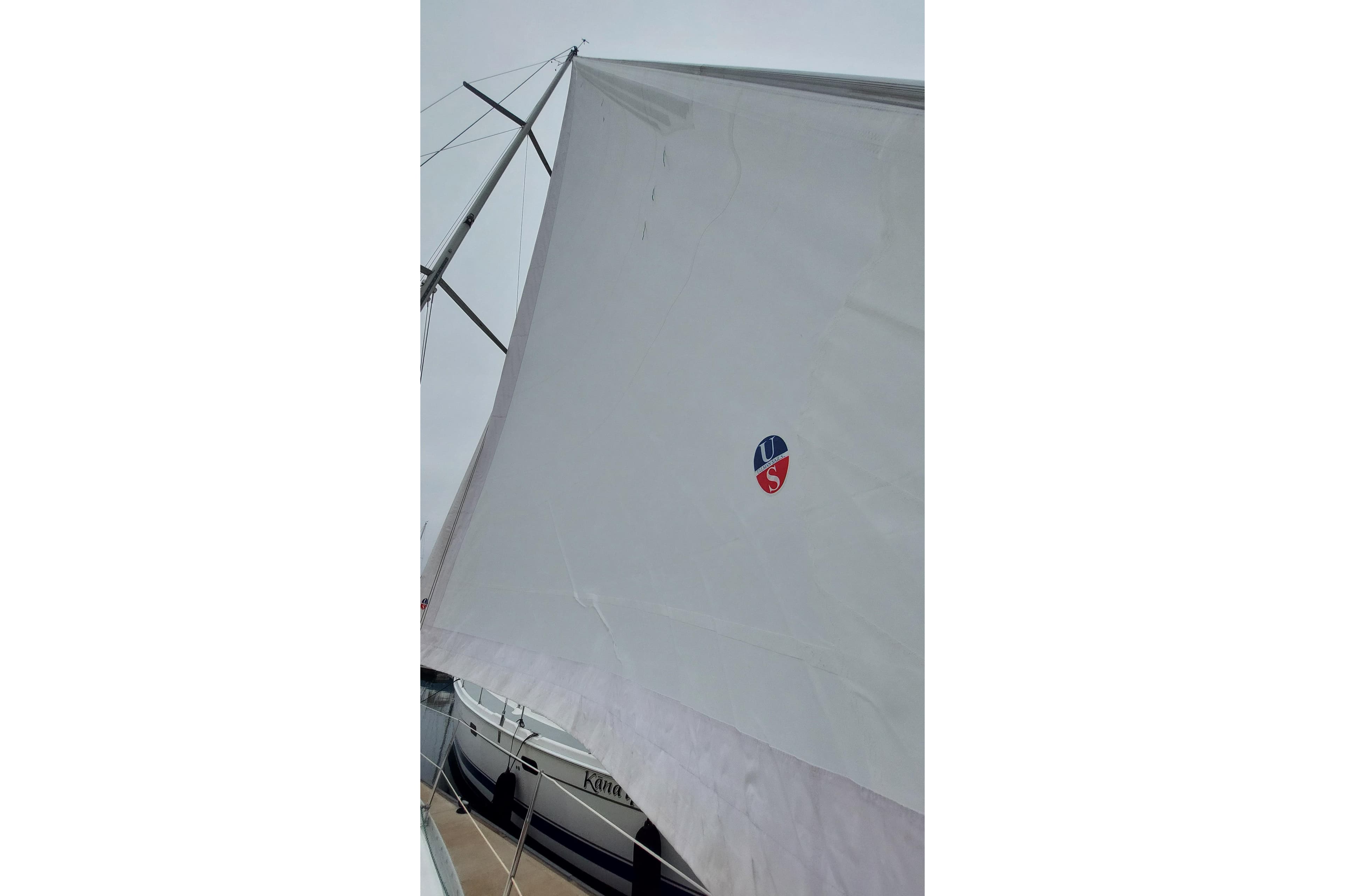 Sail of a 2002 Jeanneau Sun Odyssey 43 DS yacht, docked at a marina.