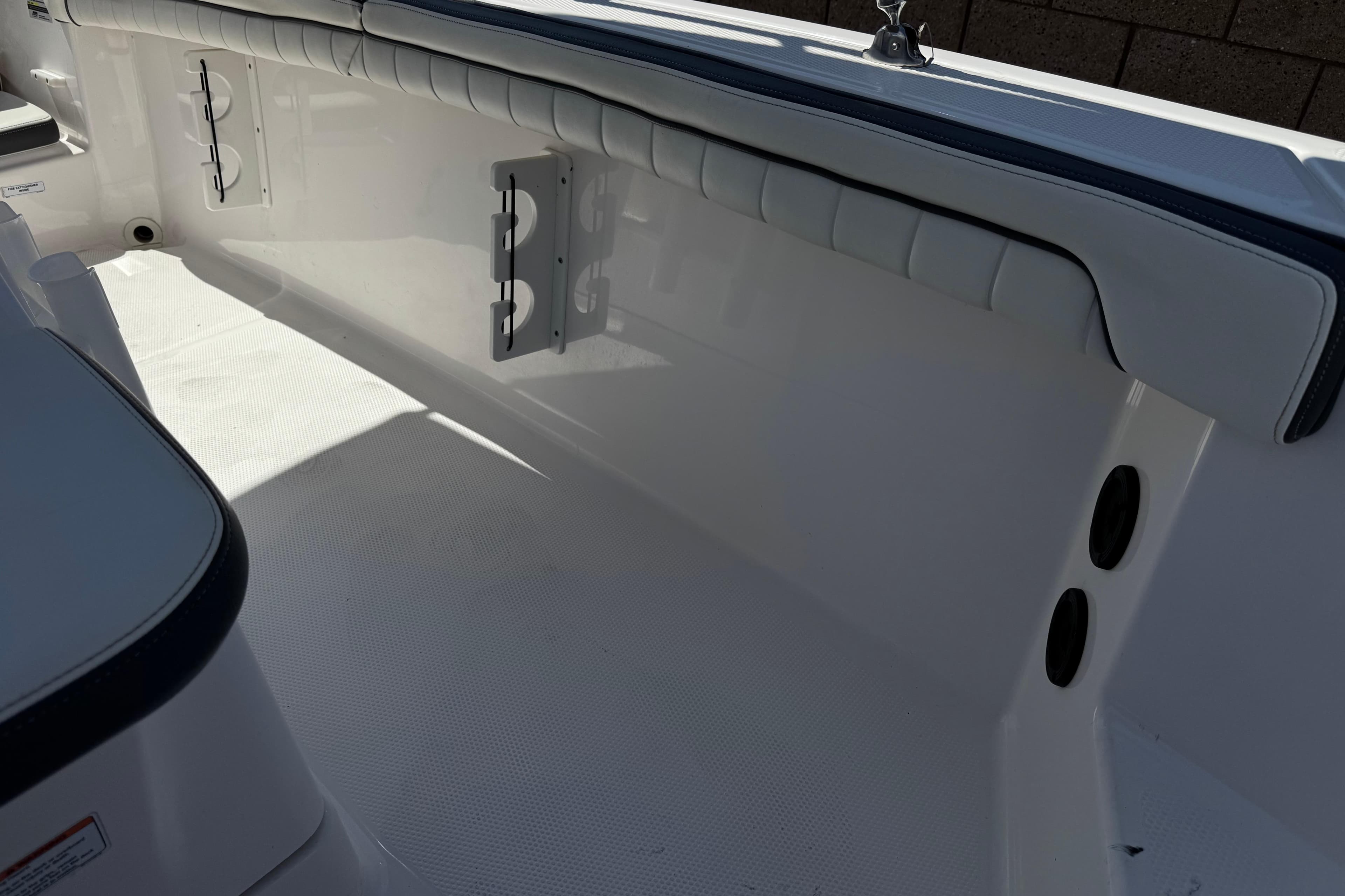 Interior view of a 2016 Yamaha Boats 190 FSH Deluxe, showcasing seating and storage.