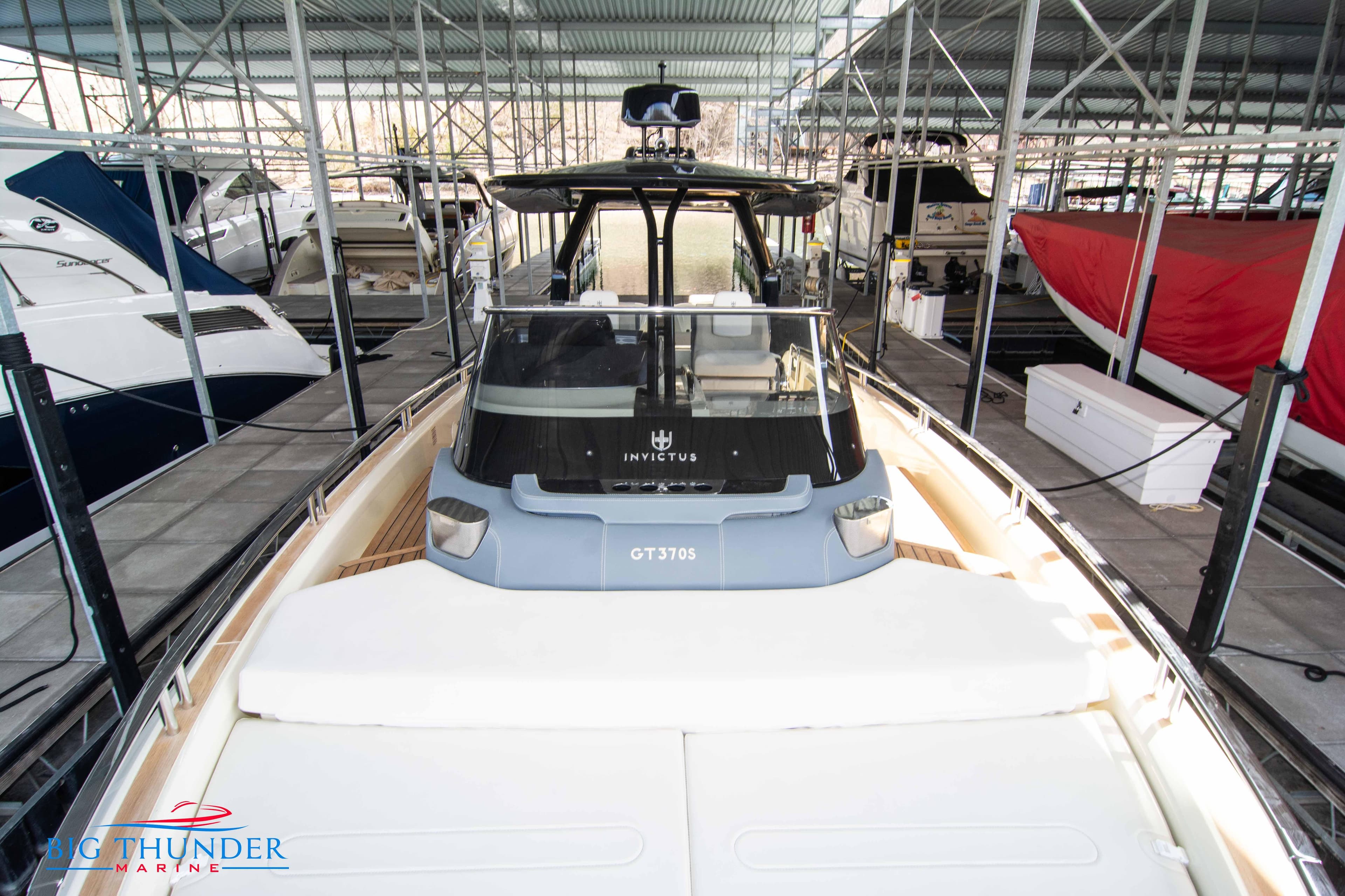 2024 Invictus GT370S luxury yacht docked in a marina.