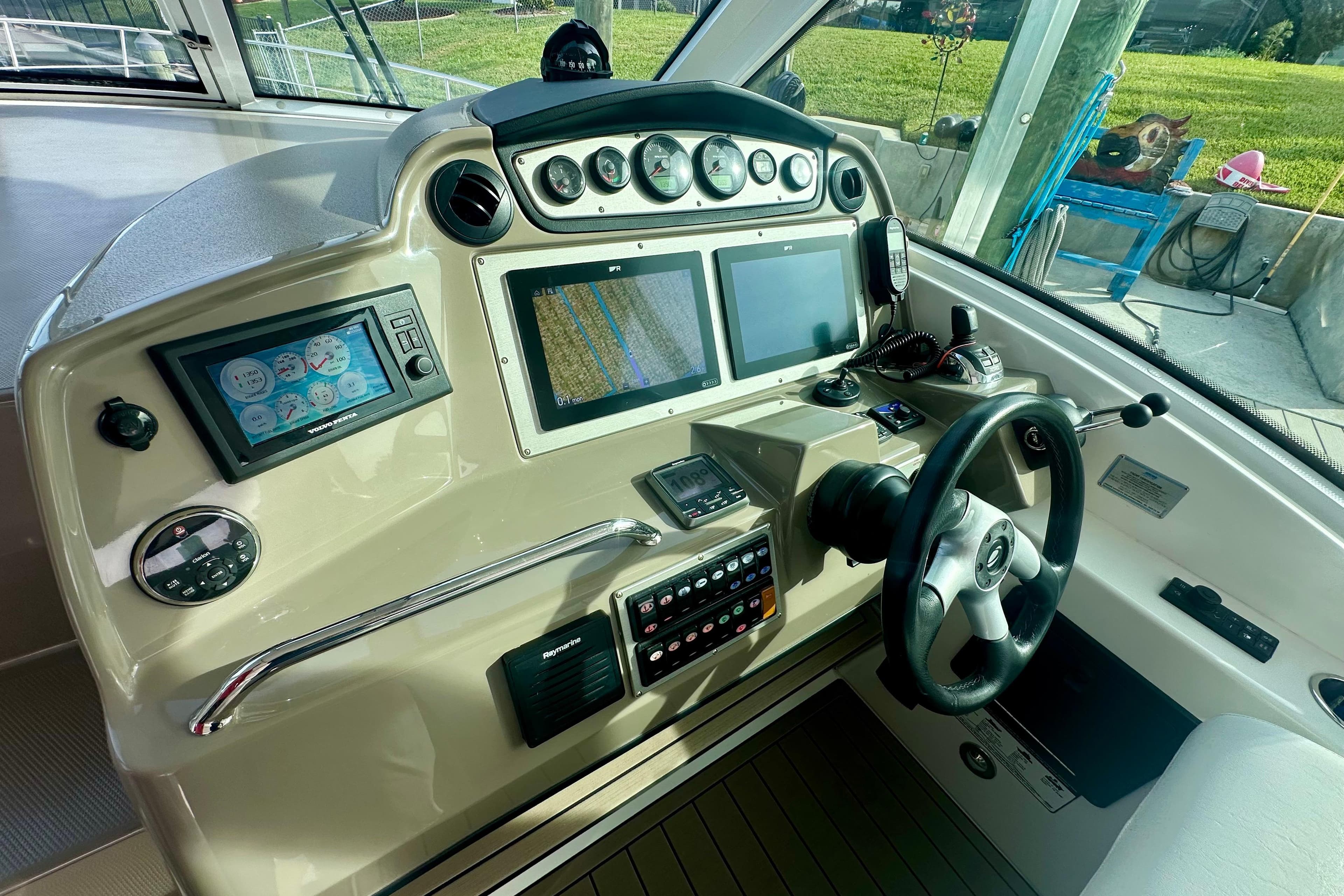 Helm of 2011 Cruisers Yachts 420 Sports Coupe with advanced navigation controls and displays.