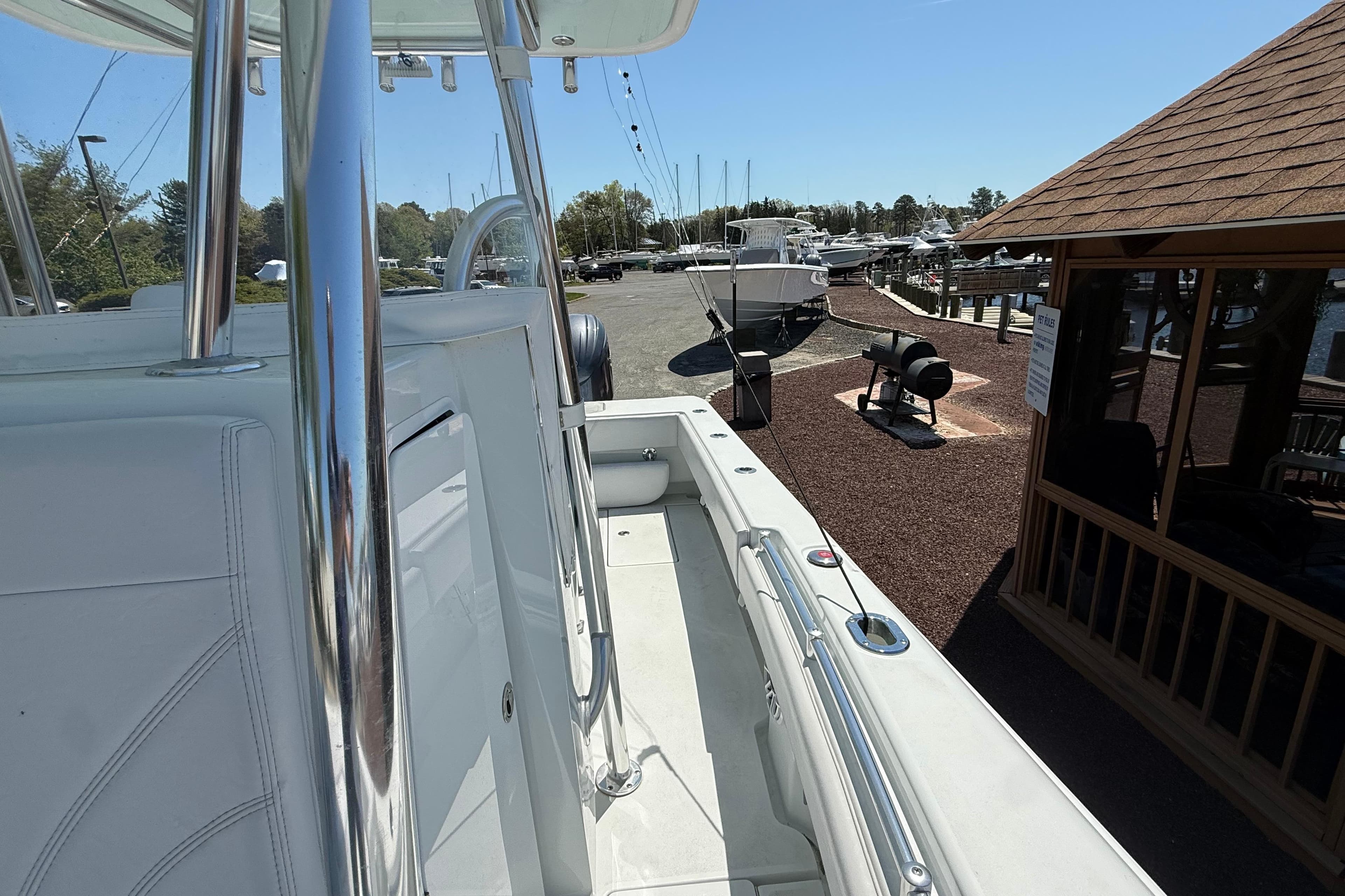 2024 Contender 25 Tournament boat docked at a marina under clear blue skies.