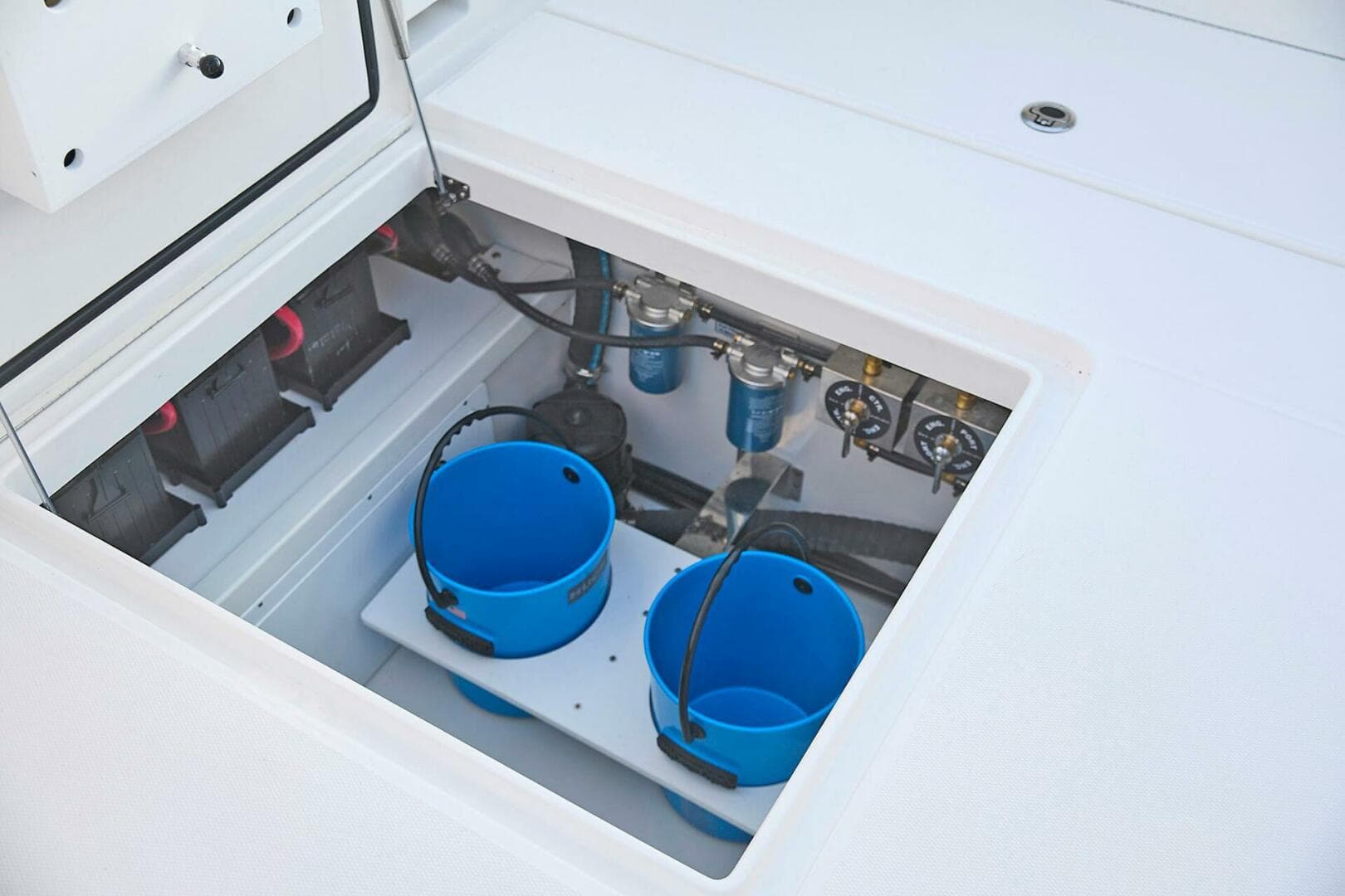 Storage compartment of 2025 Regulator 37 boat with blue buckets and equipment.