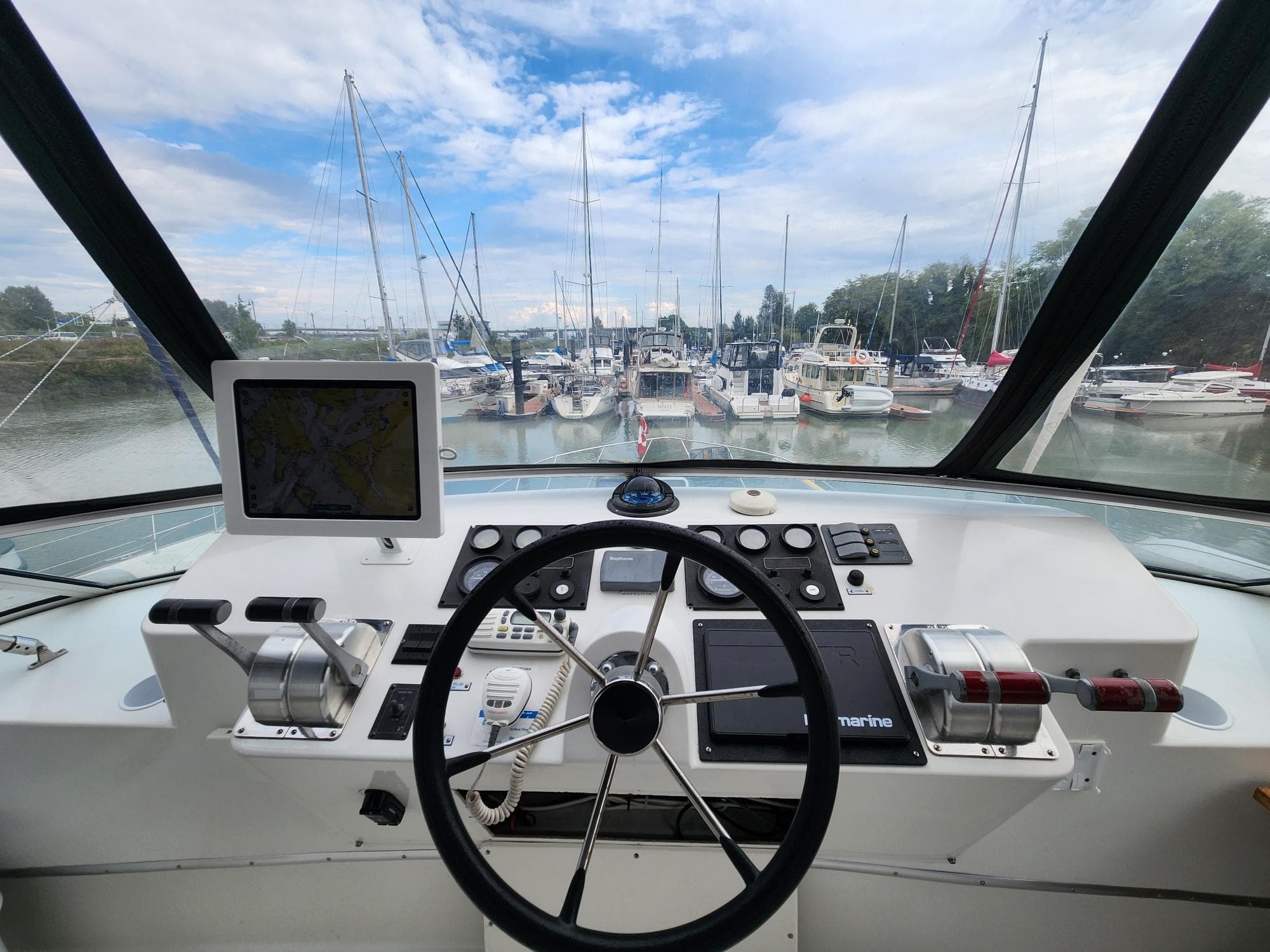 Helm of 2001 Navigator Californian 3900 yacht with marina view and navigation equipment.