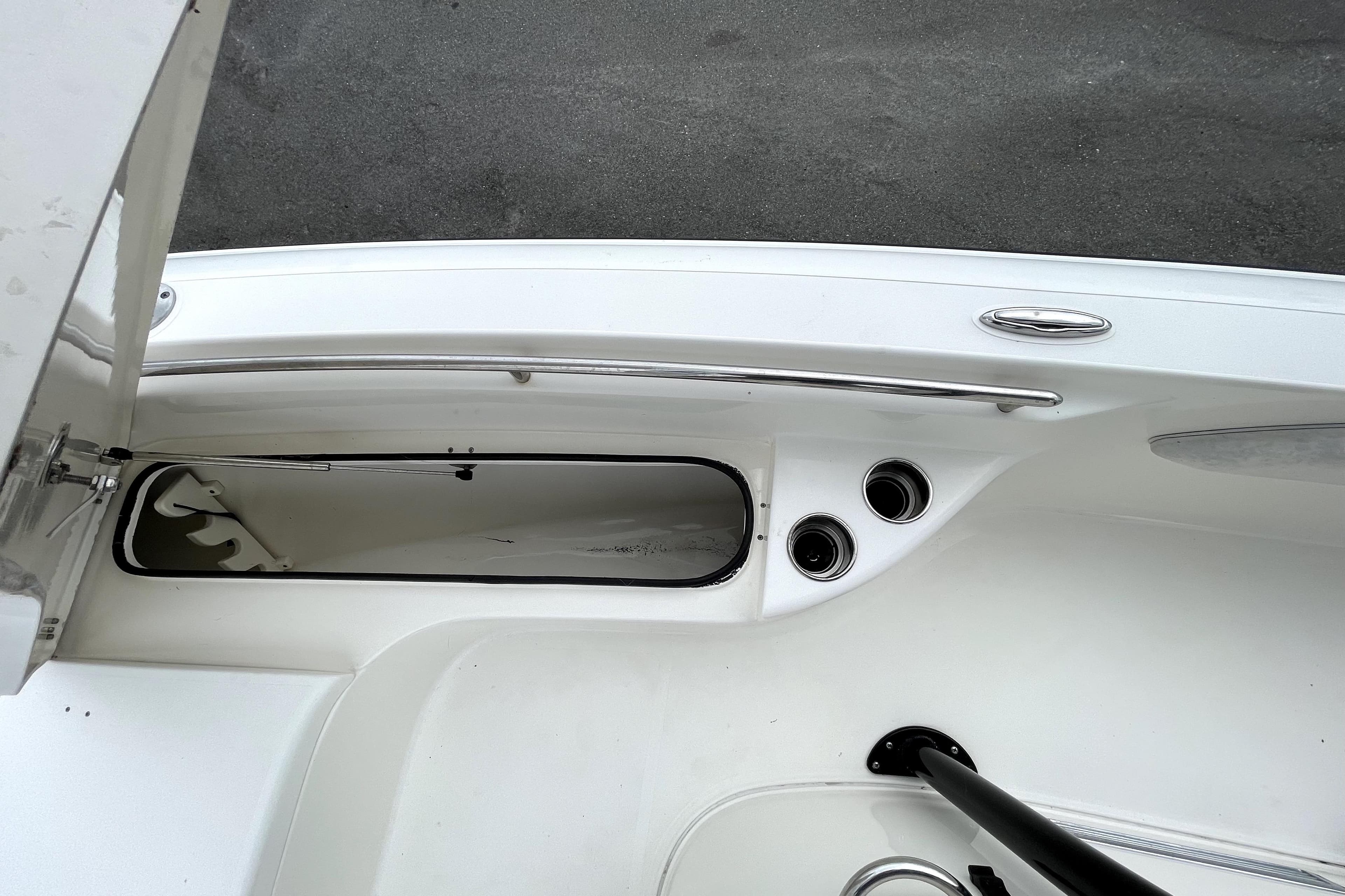2019 ShearWater 25 LTZ boat interior with storage compartment and cup holders.