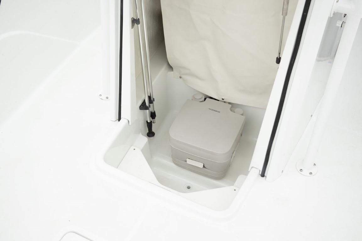 2024 Wellcraft 202 Fisherman boat interior with portable toilet.