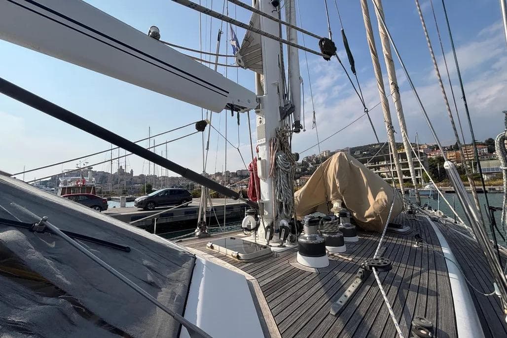 Deck view of a 1988 Jongert 2000s yacht, showcasing rigging and marina backdrop.