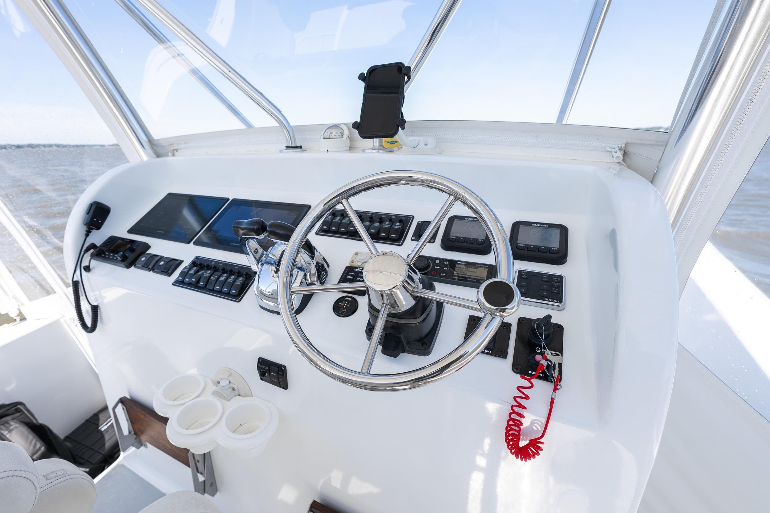 Helm of 2020 Custom Redfinn 31 boat with modern controls and steering wheel.