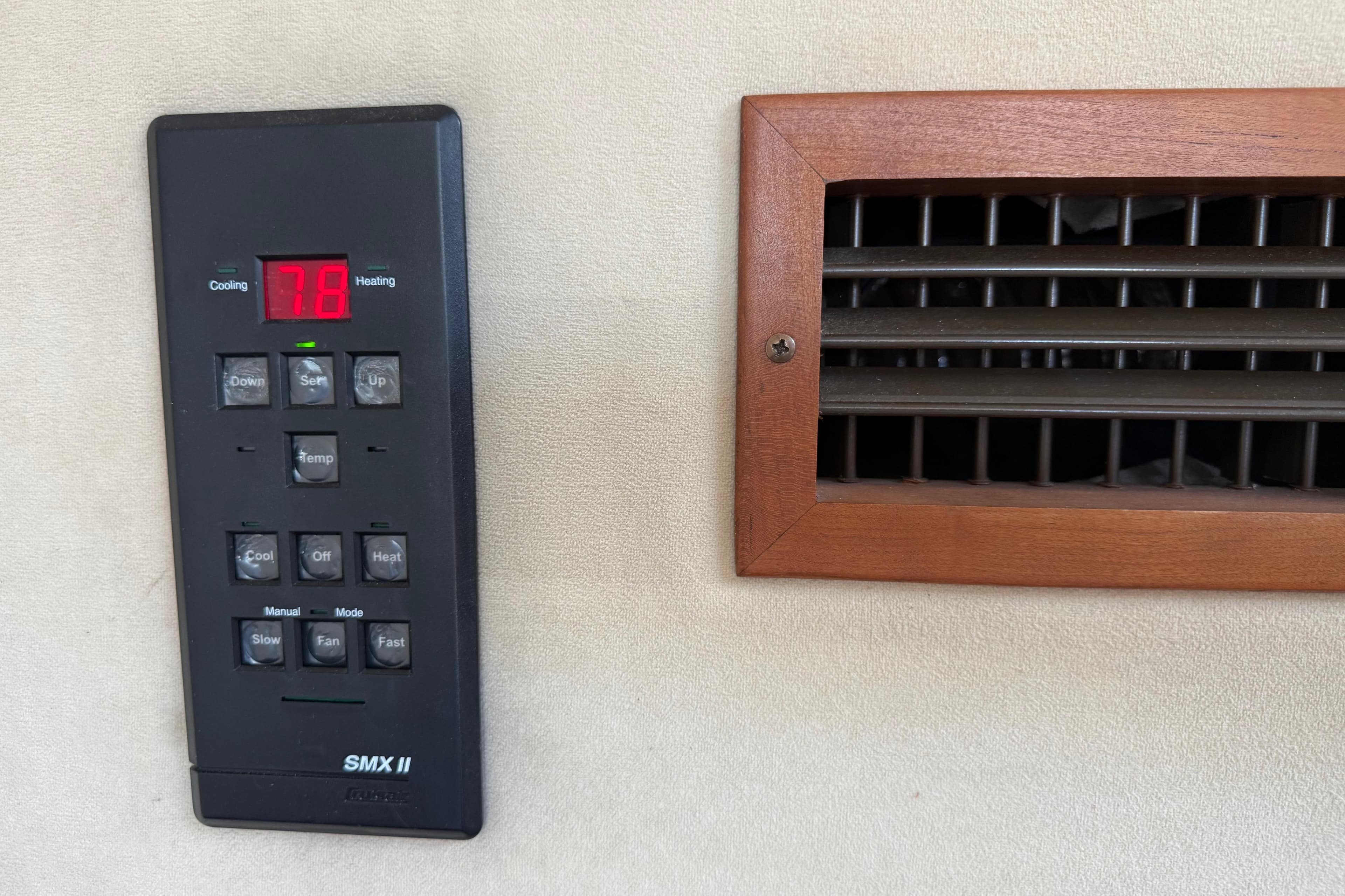 Thermostat control panel and vent on 2002 Cruisers Yachts 4450 Express Motoryacht.