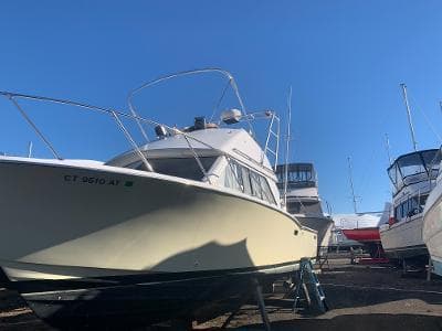 1975 Chris-Craft 30 Tournament FB boat on dry dock under clear blue sky.