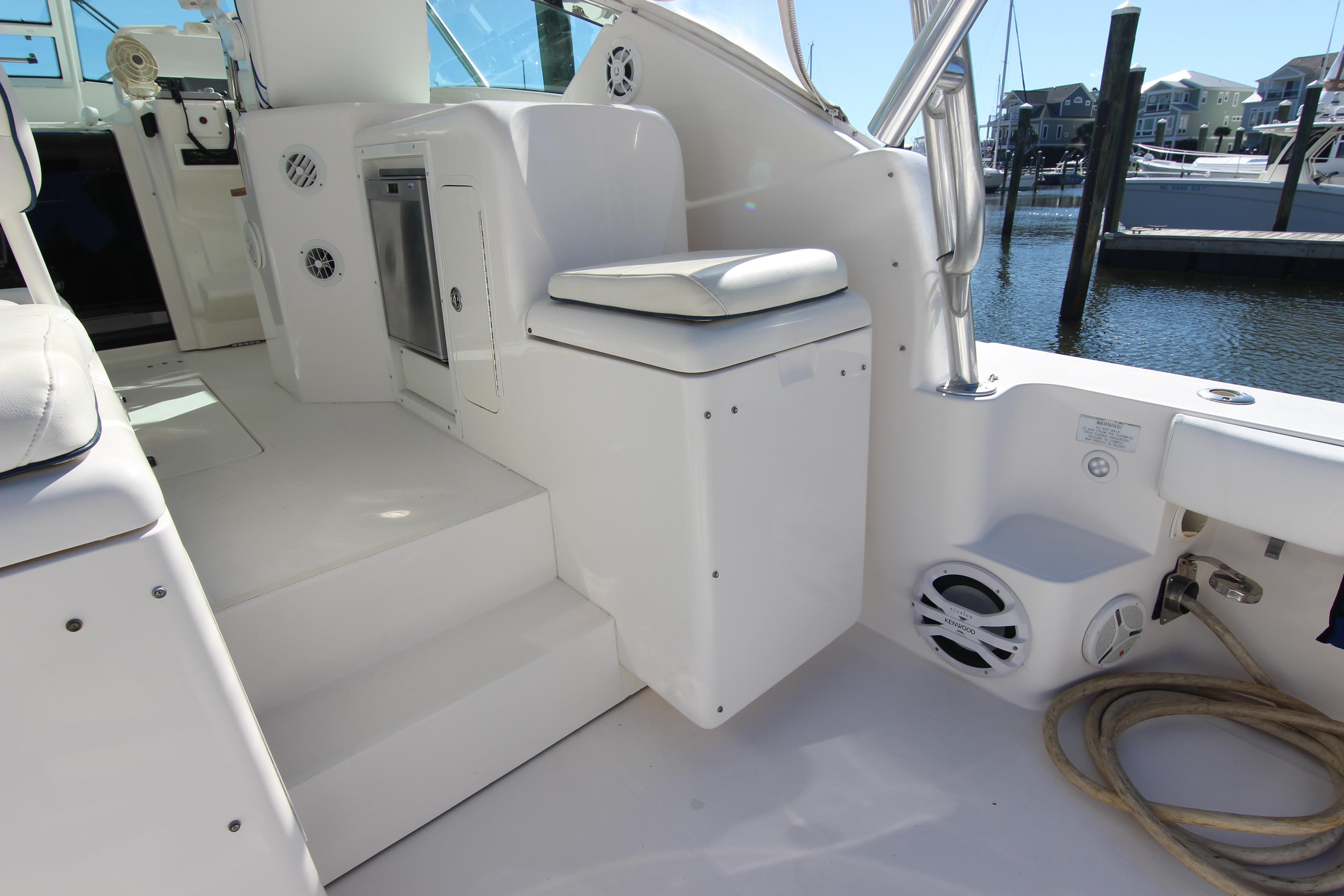 2008 Bertram 360 yacht interior with seating, steps, and marina view.