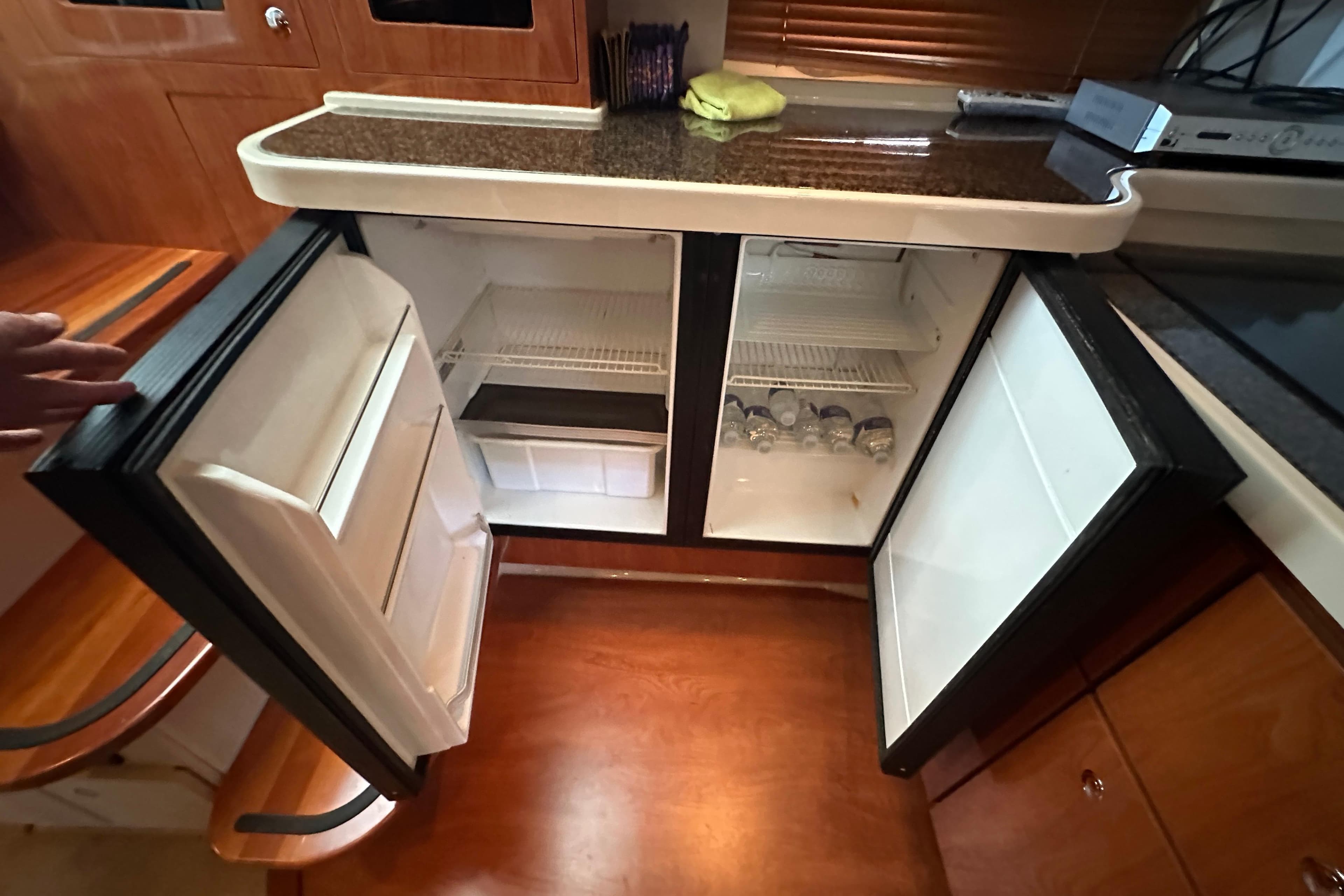 2006 Four Winns 378 Vista yacht kitchen with open dual refrigerators.