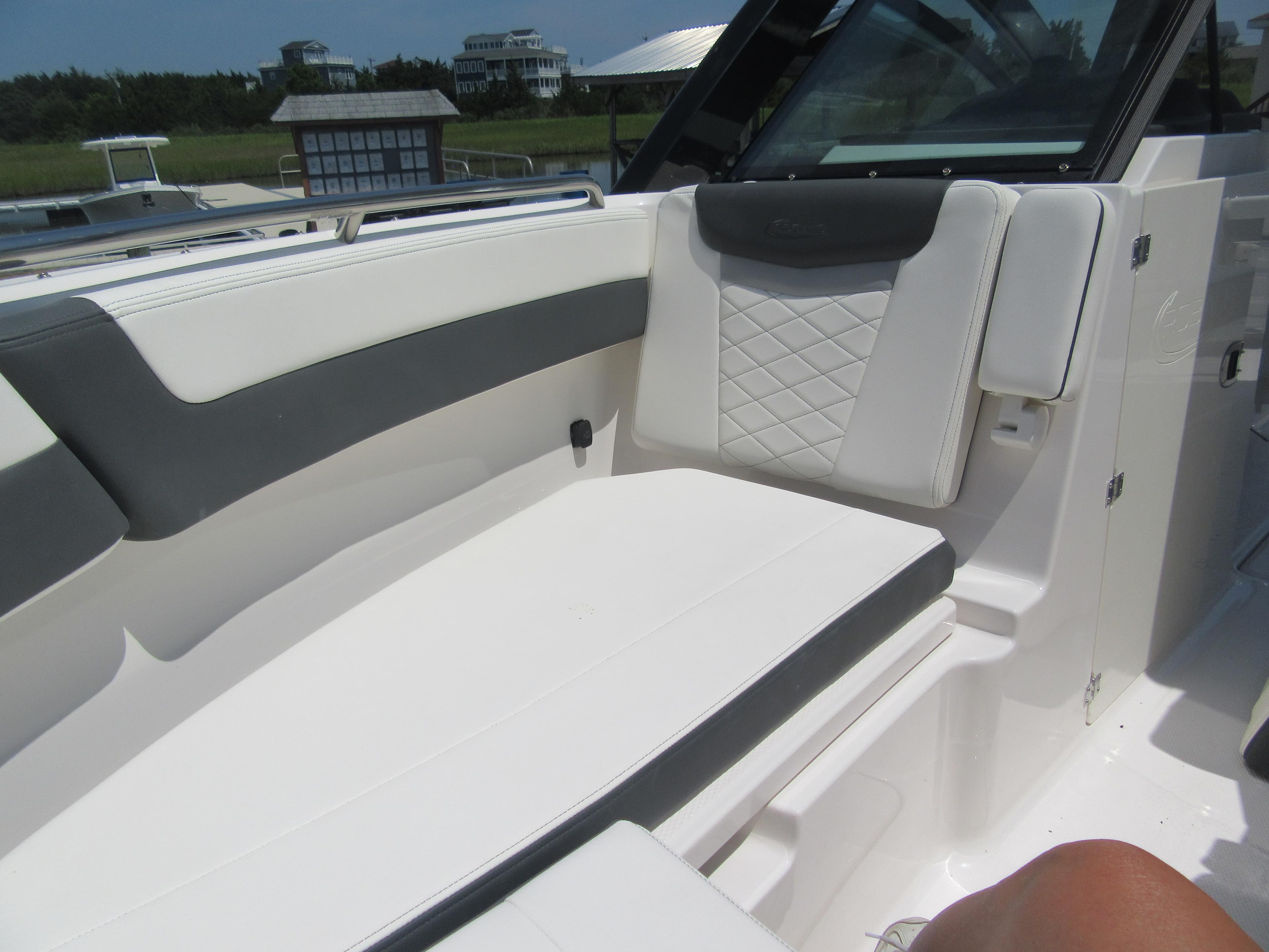 2025 Robalo R257 Dual Console boat interior with white and gray seating.