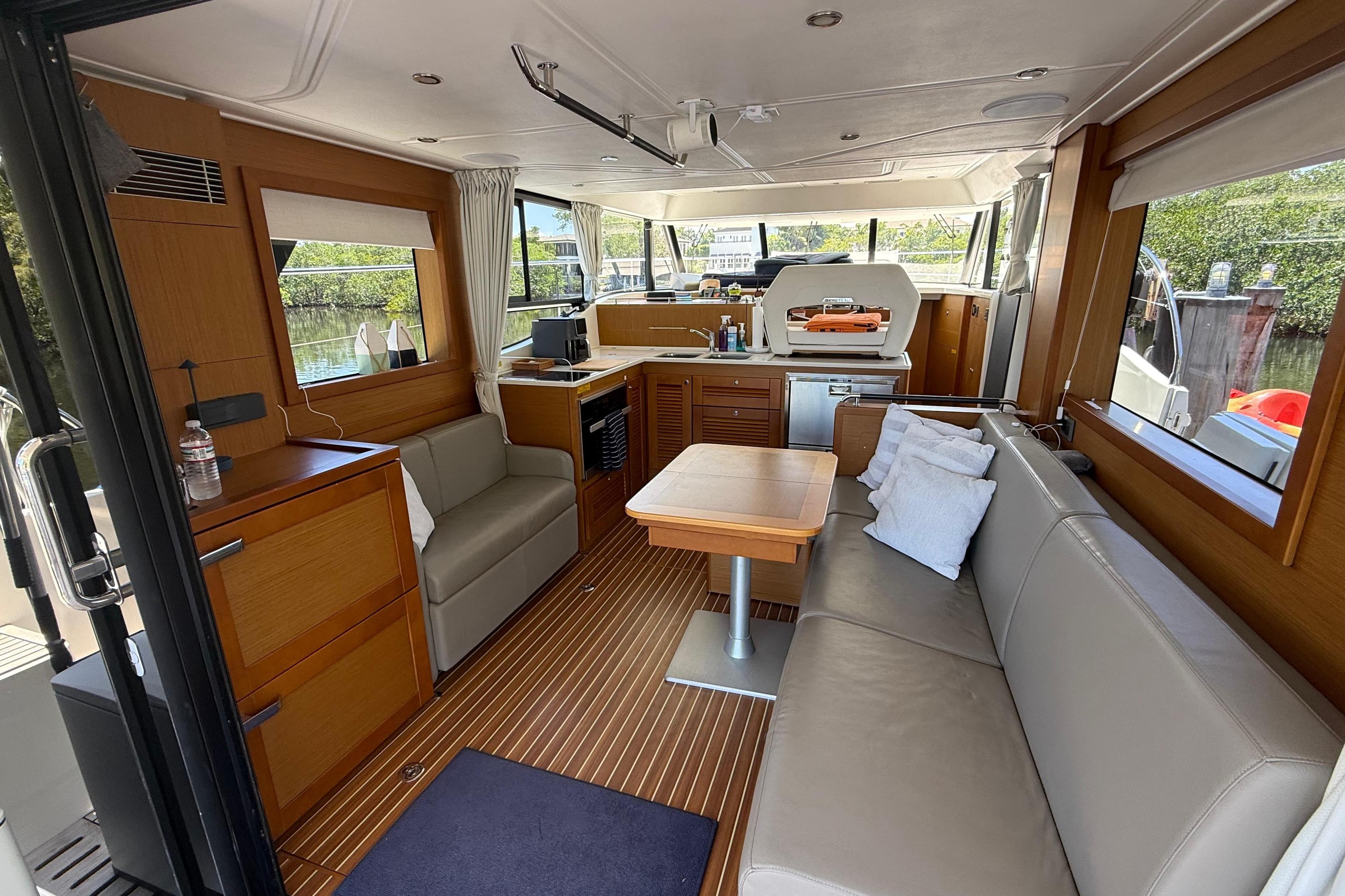 Interior of 2019 Beneteau Swift Trawler 47, featuring modern seating and wooden finishes.
