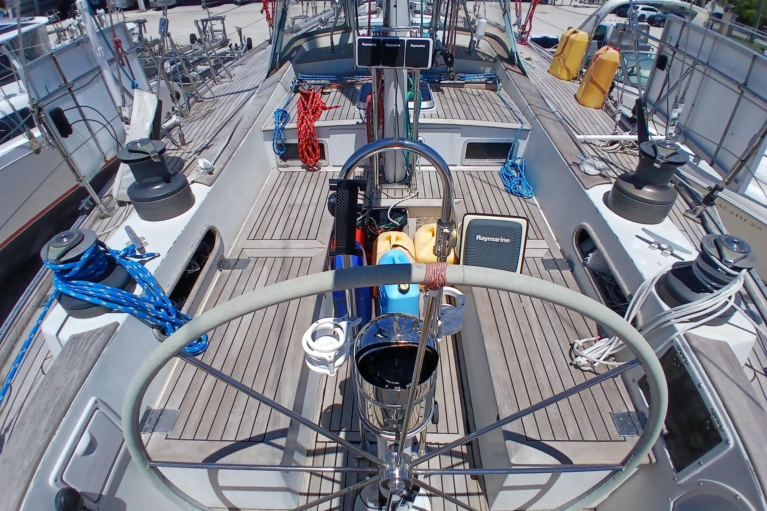 Cockpit view of 1981 Kaufman Skye 51 sailboat with nautical equipment and ropes.