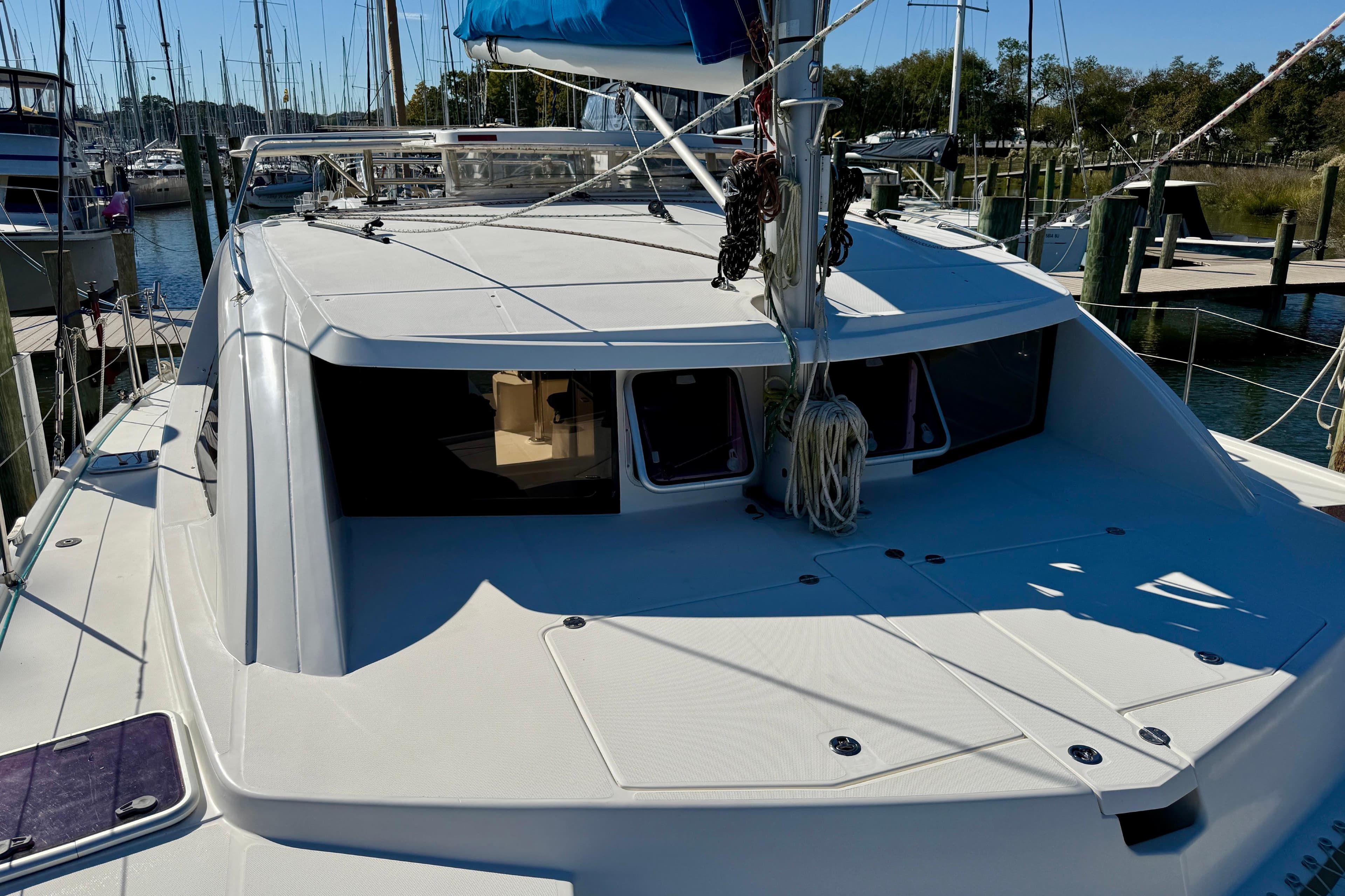 2010 Leopard 38 catamaran docked at marina, showcasing sleek deck design.