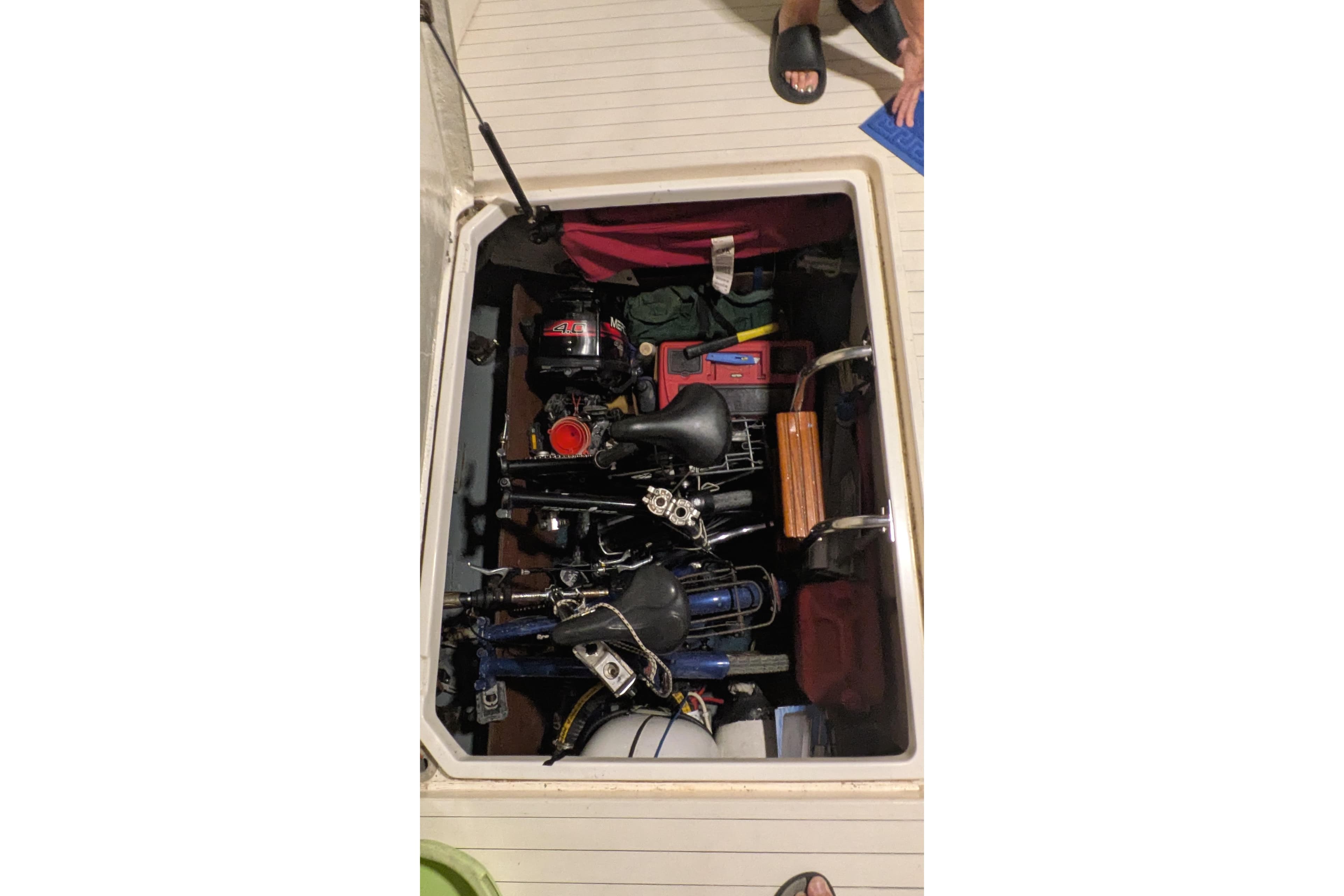 Storage compartment of 1987 Princess 385 yacht filled with various equipment and tools.