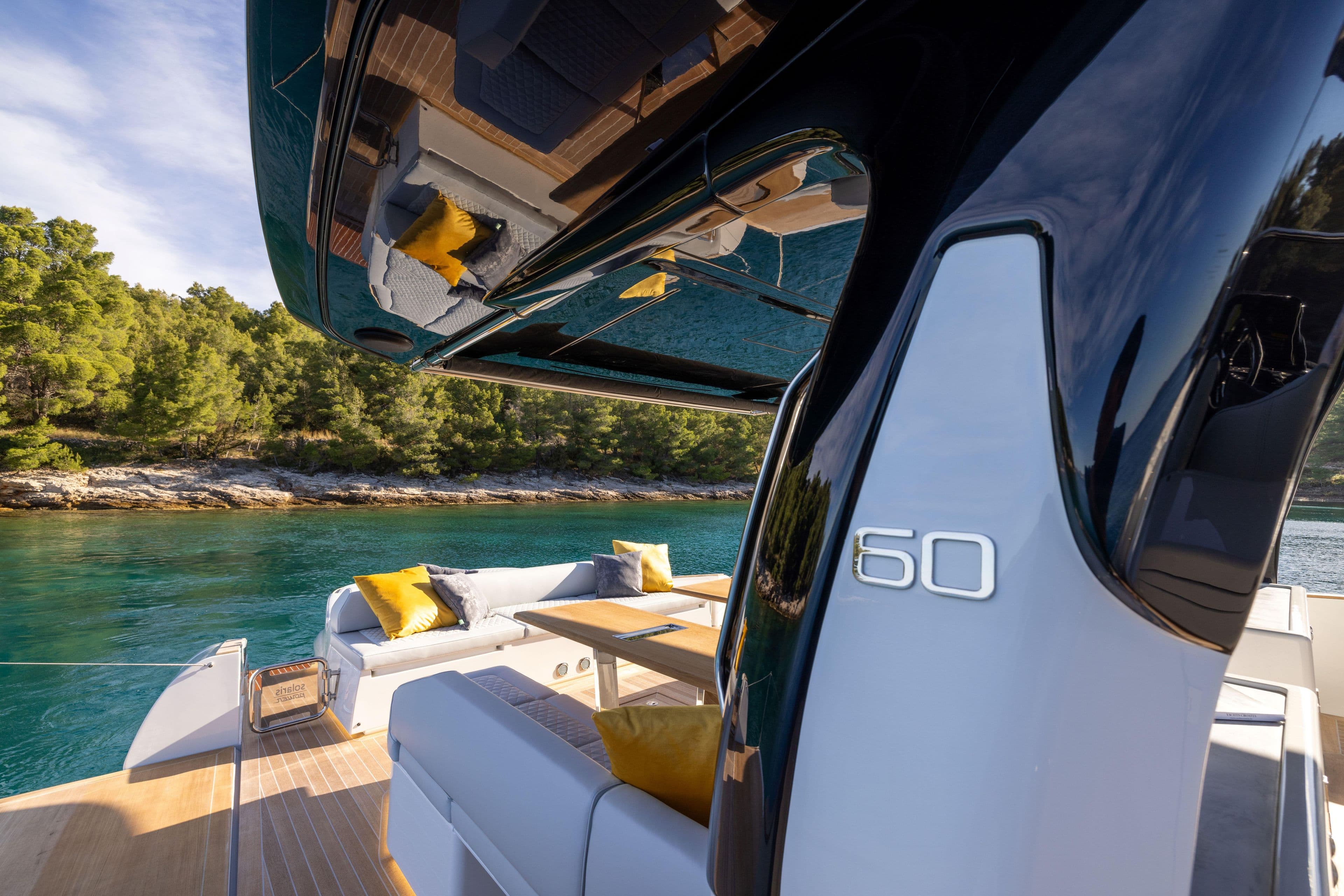 2025 Solaris Power 60 Open yacht, luxurious deck with scenic water view.