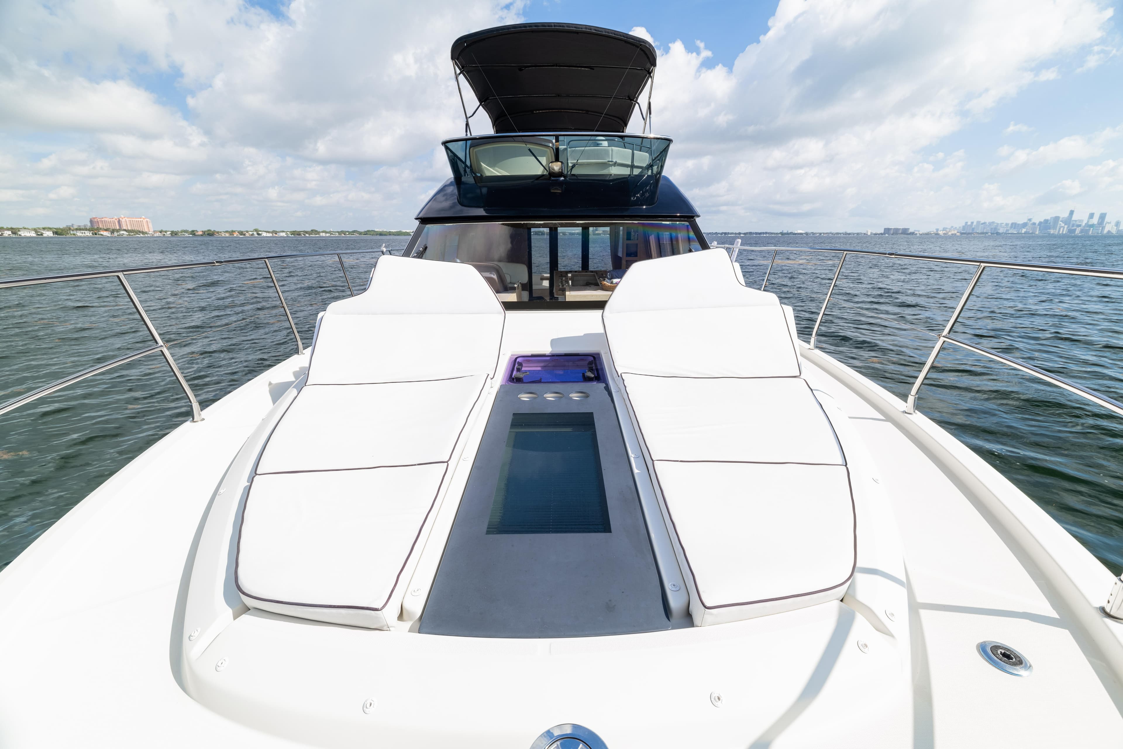 2017 Monte Carlo Yachts MC5 with sun loungers on deck, cruising on open water.