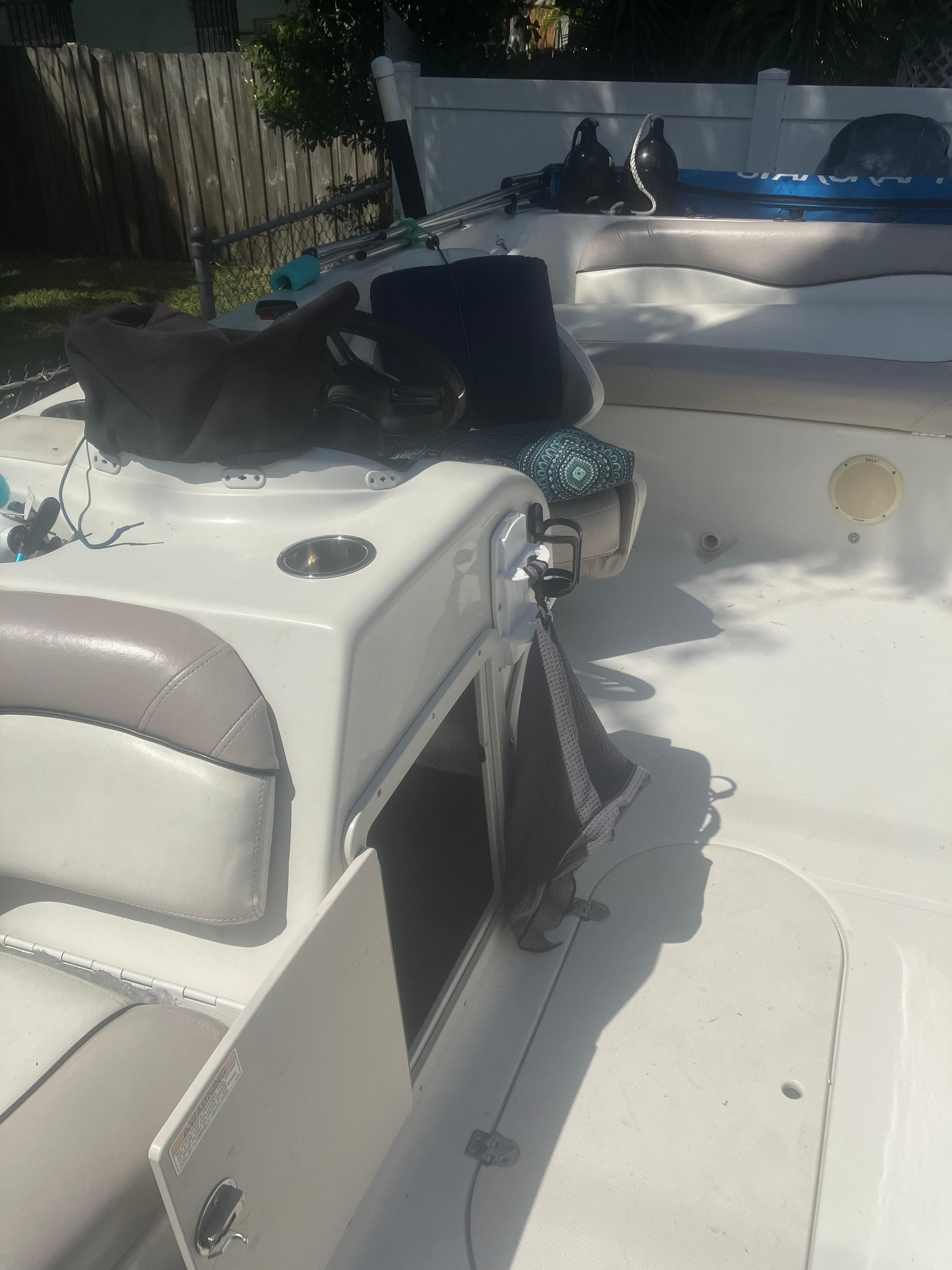 2018 Starcraft Limited 2000 OB Fish boat interior with open storage compartment.