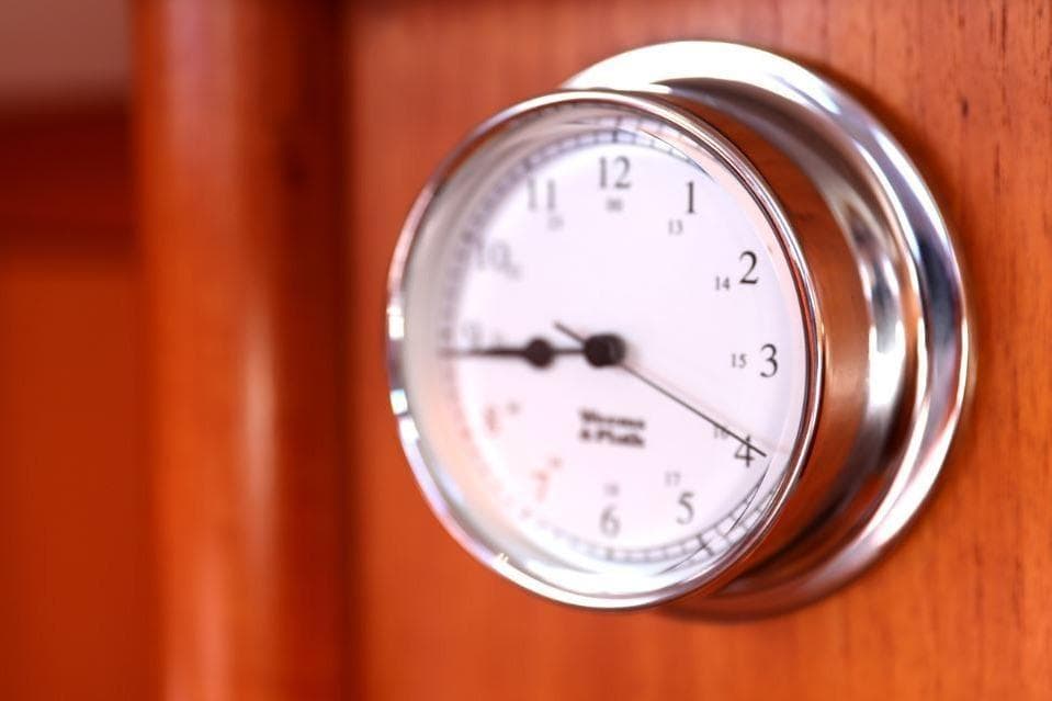 Chrome clock on wooden panel, Nautor Swan 48 yacht, 1996 model.