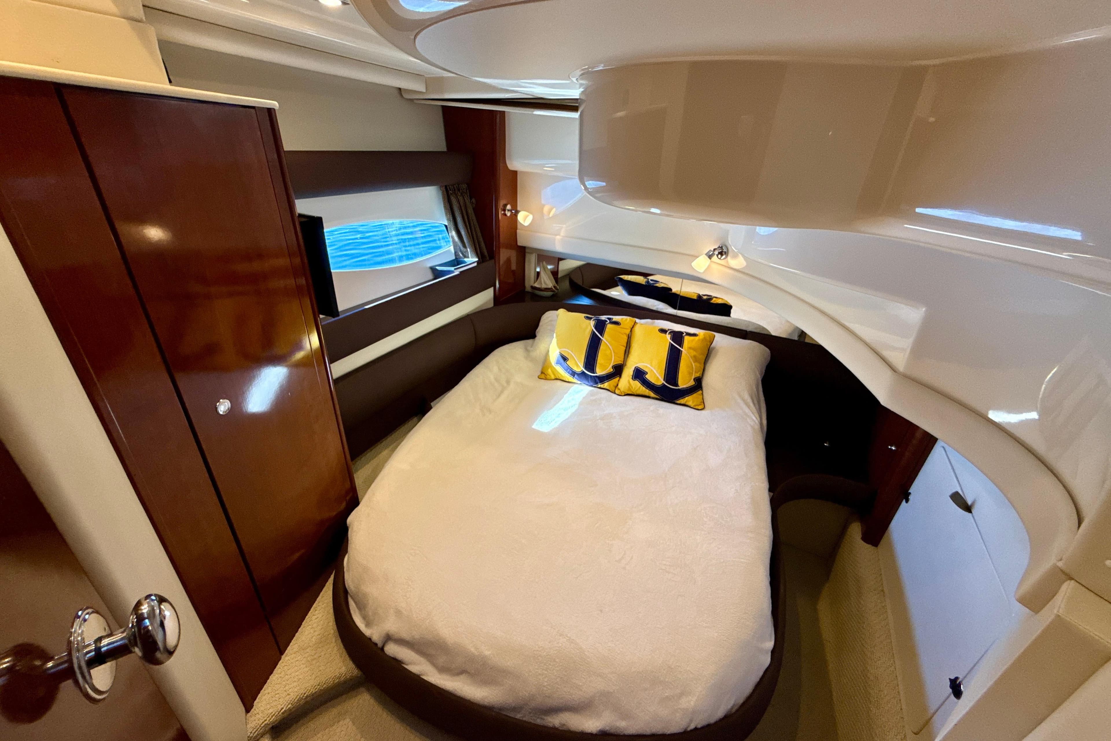 Luxurious cabin interior of 2009 Meridian 391 Sedan yacht with cozy bed and nautical decor.