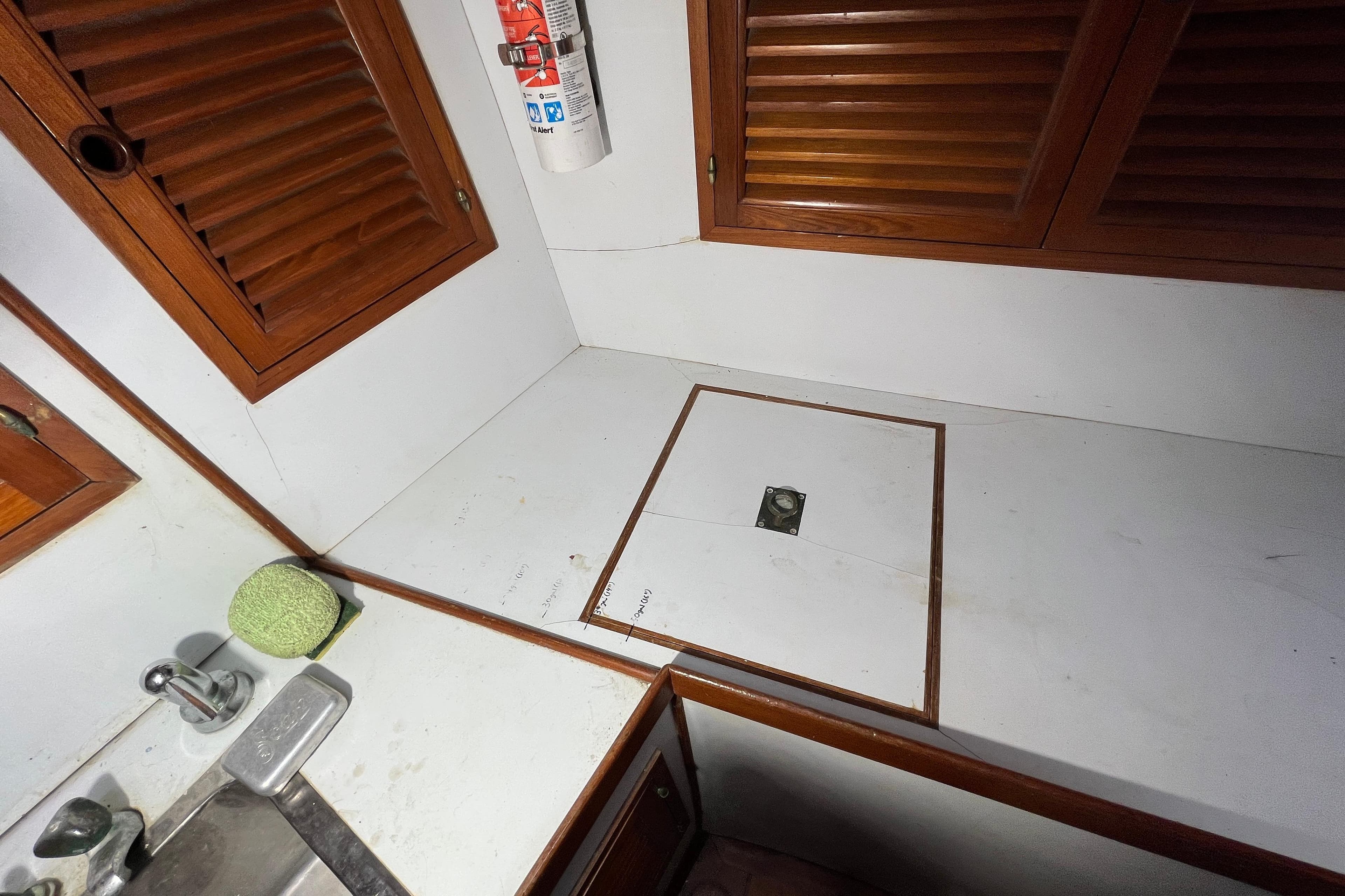Interior of 1982 Tayana 37 sailboat with wooden cabinets and countertop.