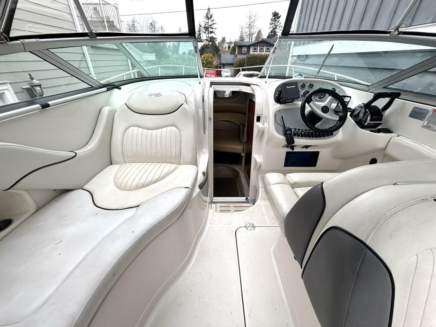 2006 Monterey 298SC Super Sport boat interior with steering wheel and seating.
