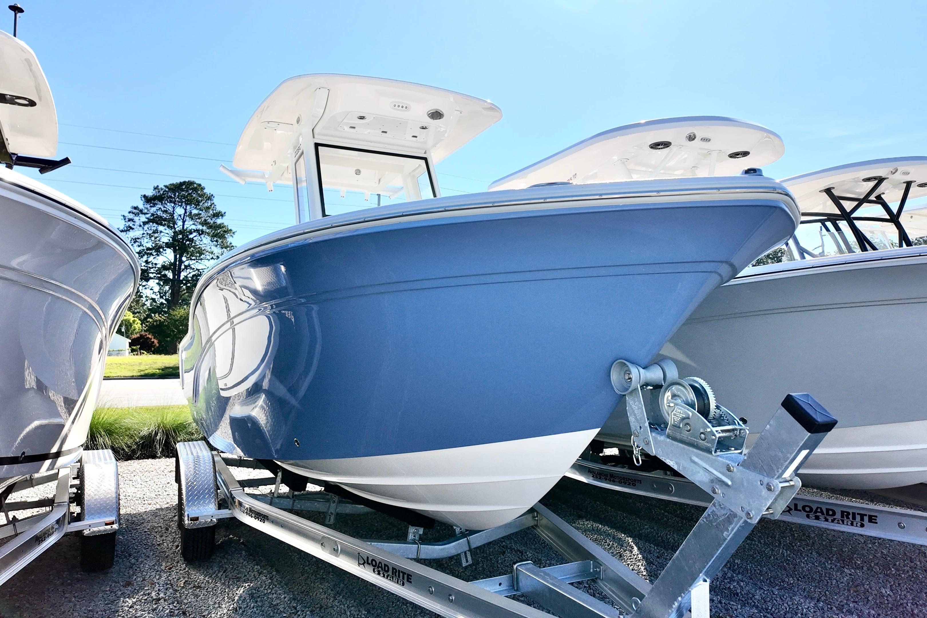 2026 Sea Fox 228 Commander boat on trailer, displayed outdoors under clear sky.