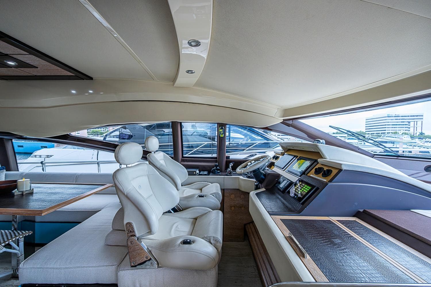 Luxurious interior of a 2011 Azimut 70 yacht with modern helm and seating.