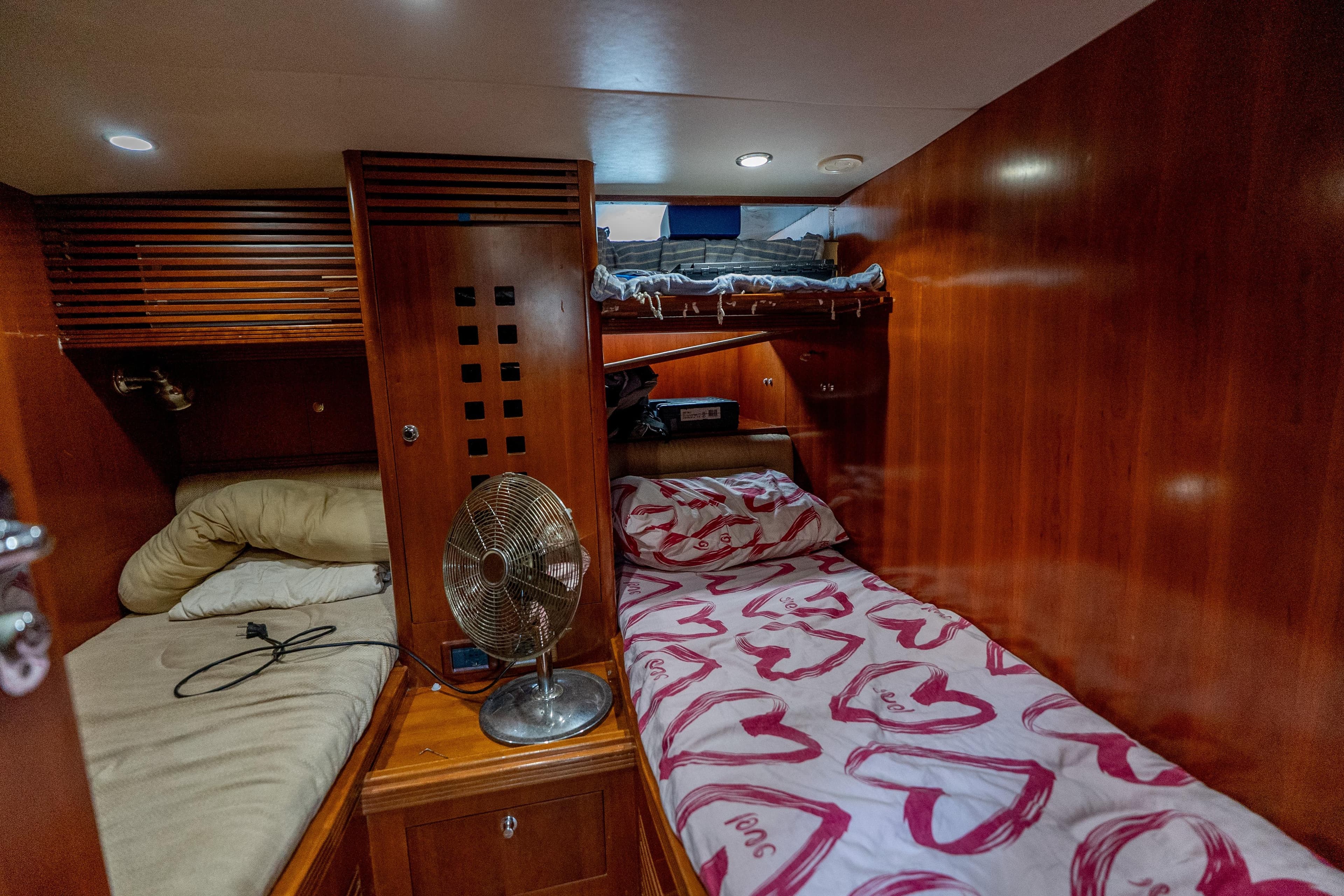 Cozy cabin interior of 2004 Selene 62 yacht with wooden paneling and bunk beds.