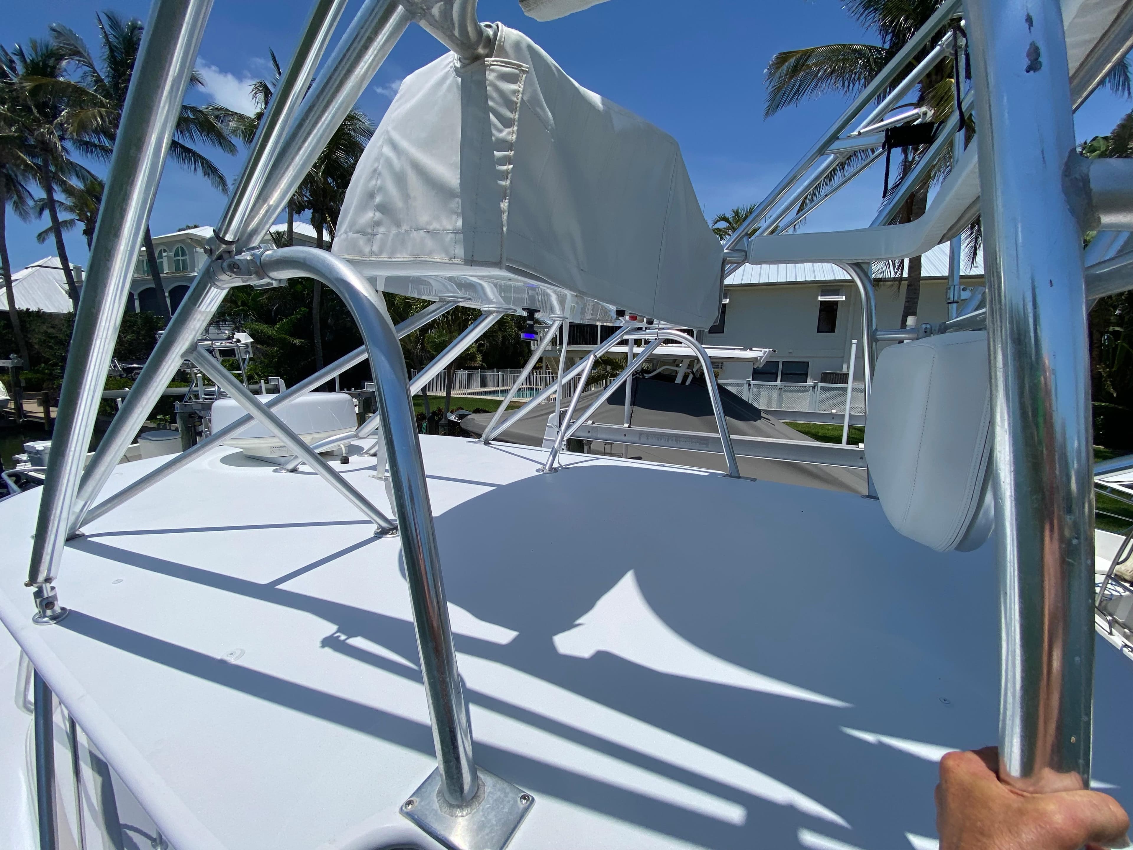 Rooftop view of a 1995 L&H 33 boat with metal railings and clear blue sky.