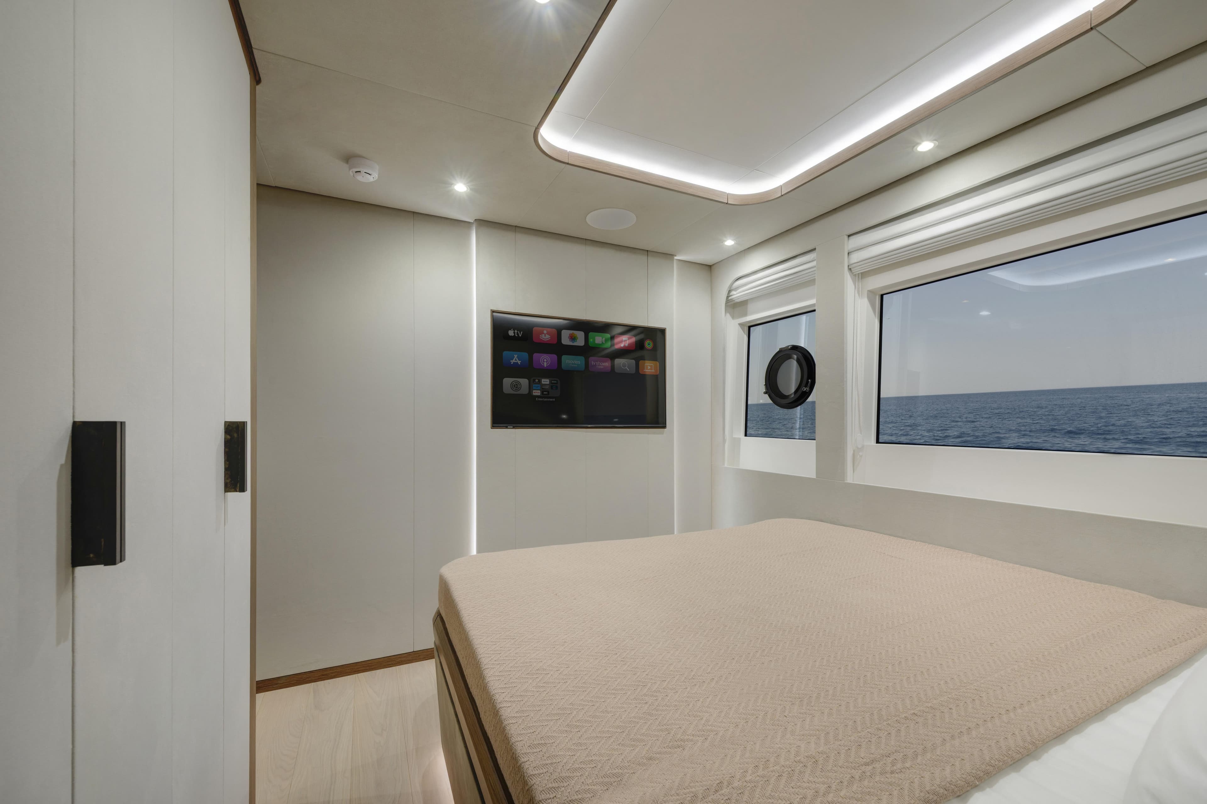 Luxurious cabin interior of 2027 Lazzara LPC 300 yacht with ocean view and modern amenities.